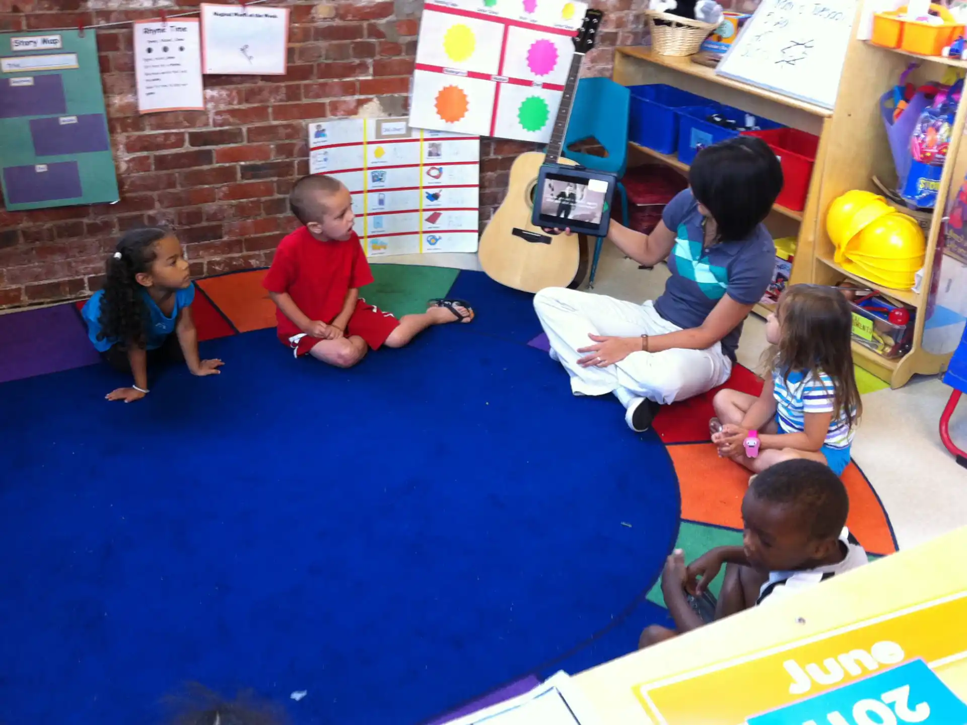 a group of children sitting on the floor reading books