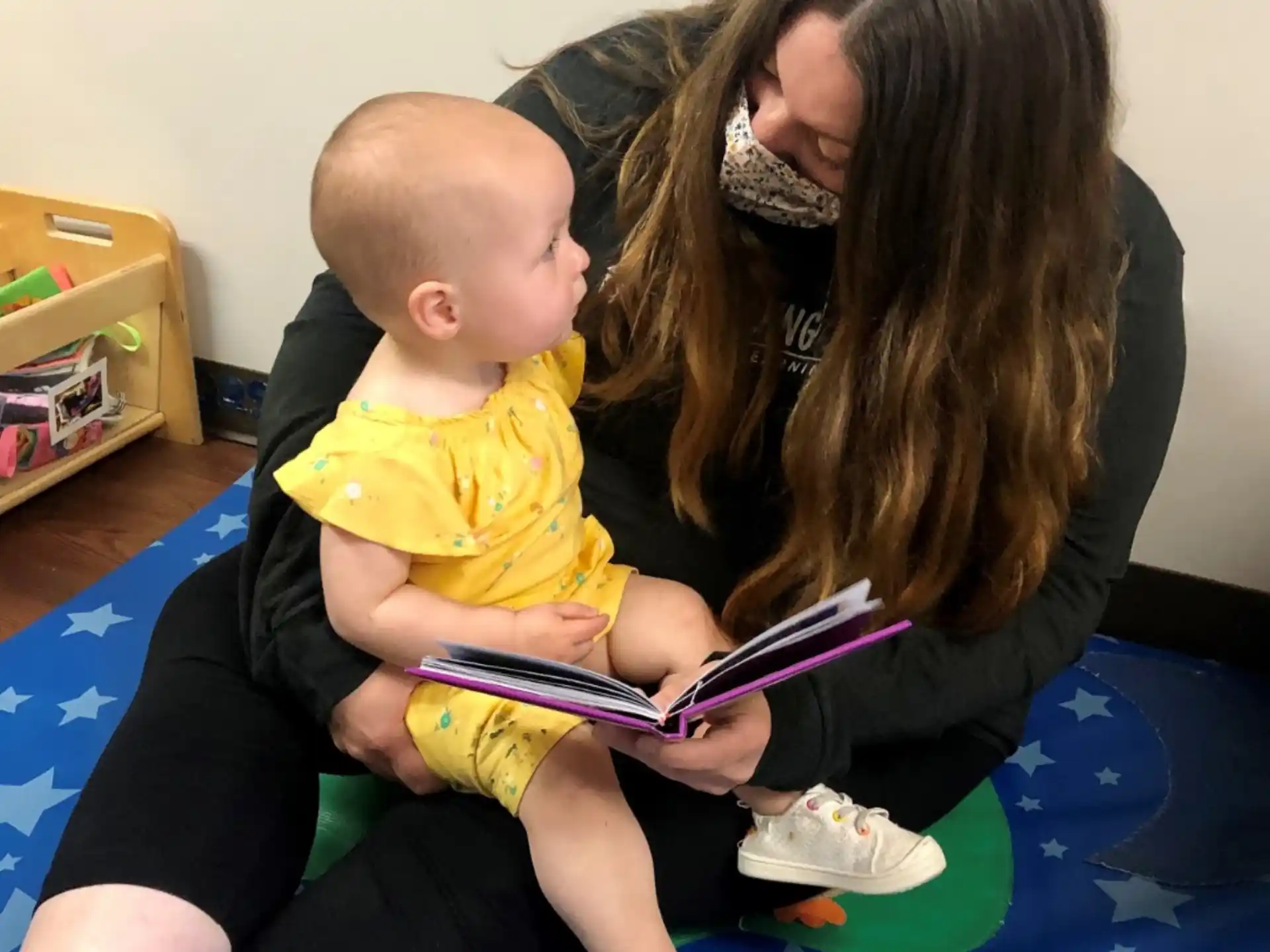 a woman holding a baby