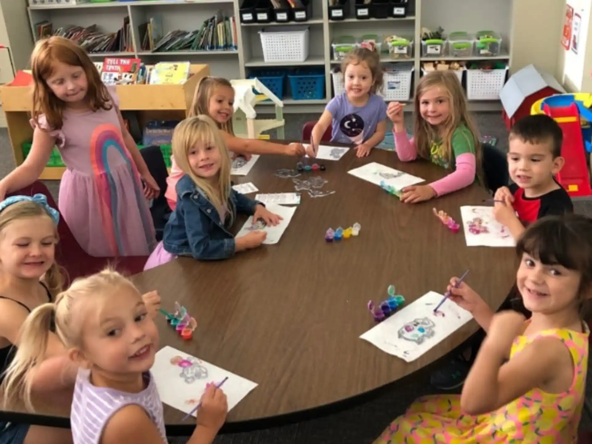 a group of children sitting at a table