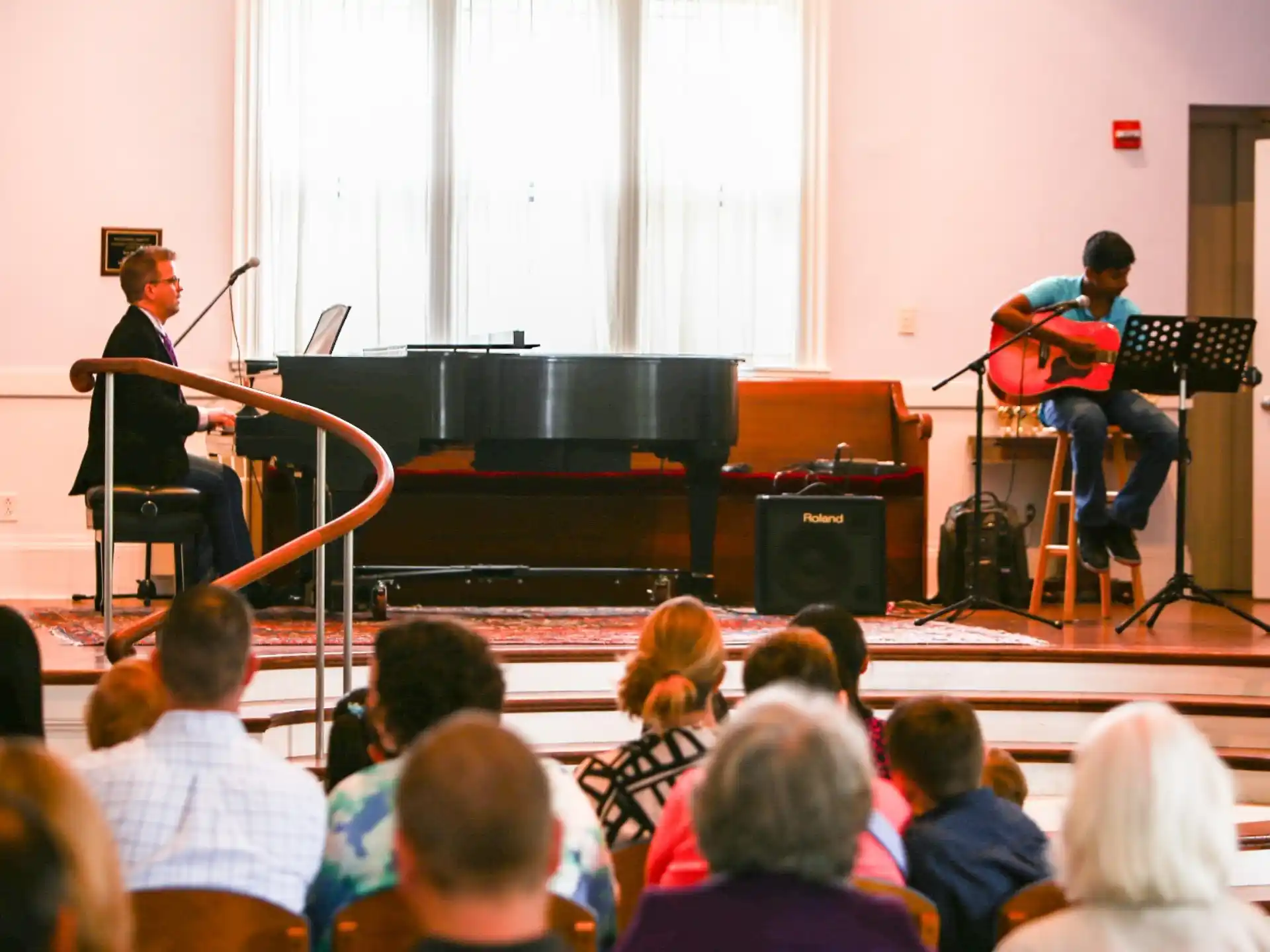 a group of people playing instruments on a stage