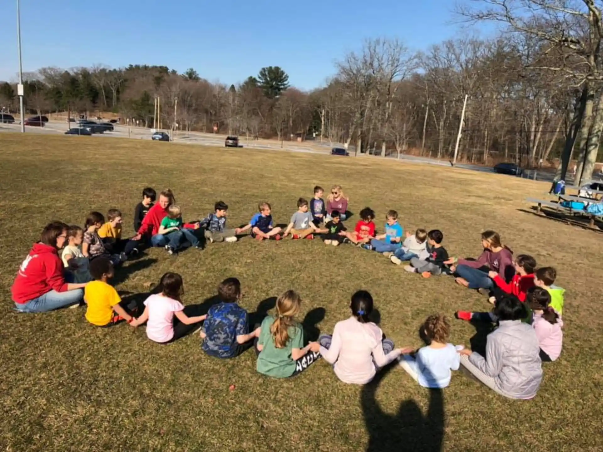 a group of people sitting on the grass