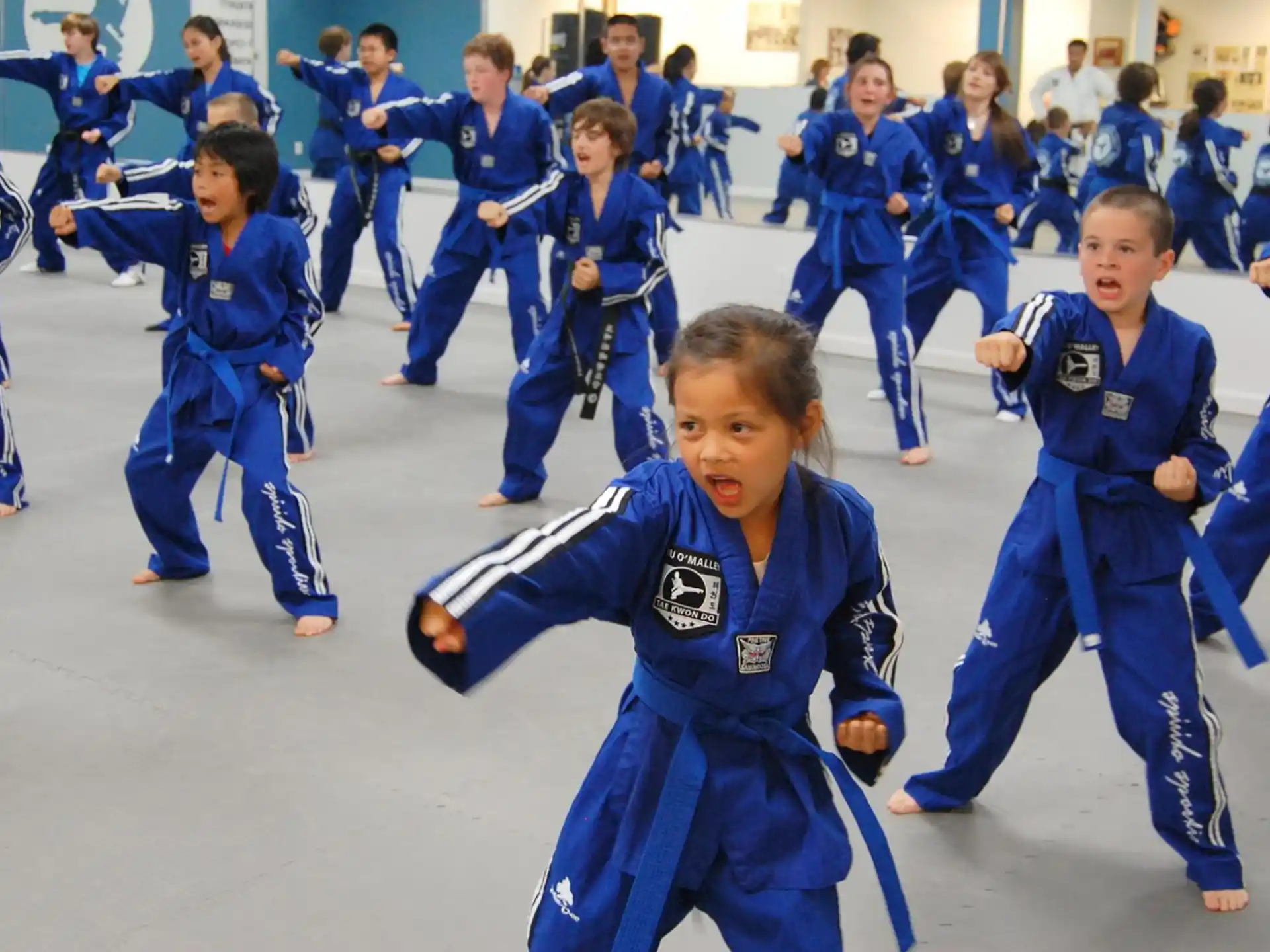 a group of children in blue uniforms