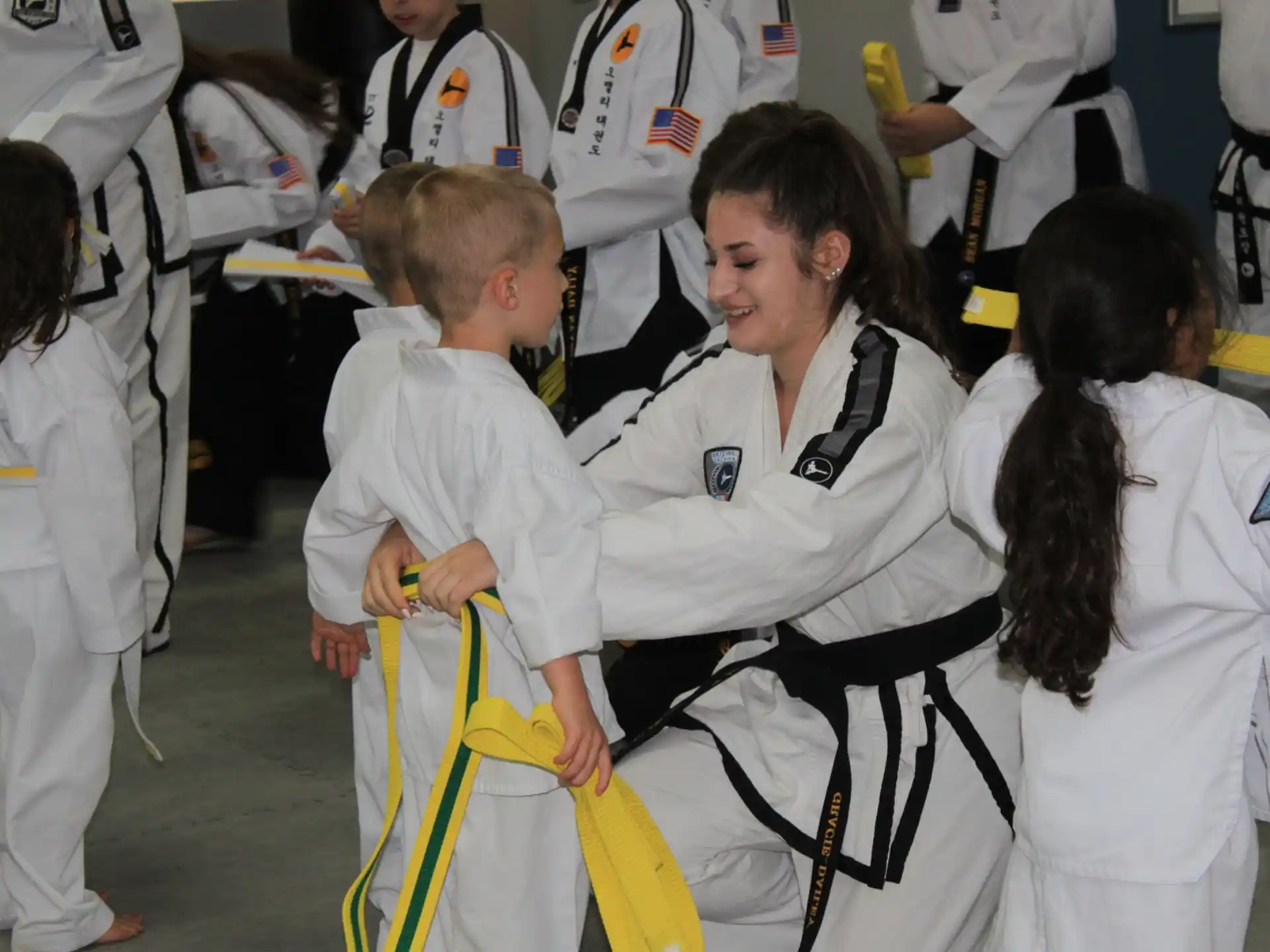 a group of people in white karate uniforms