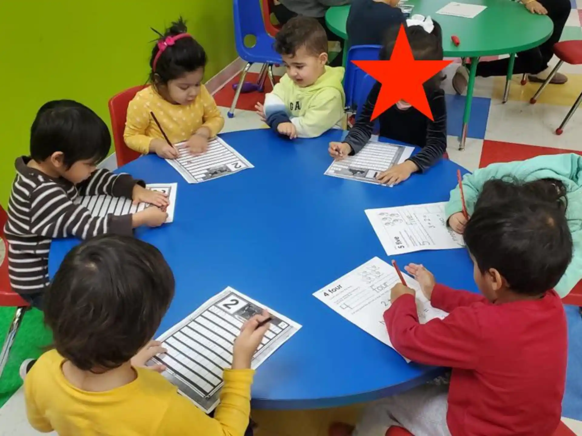 a group of children sitting around a table