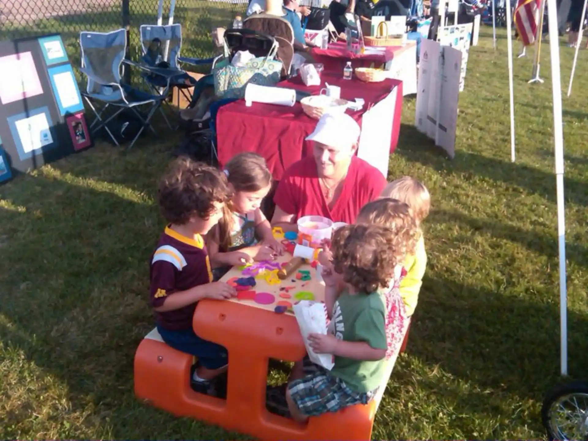 a person and several children sitting at a table