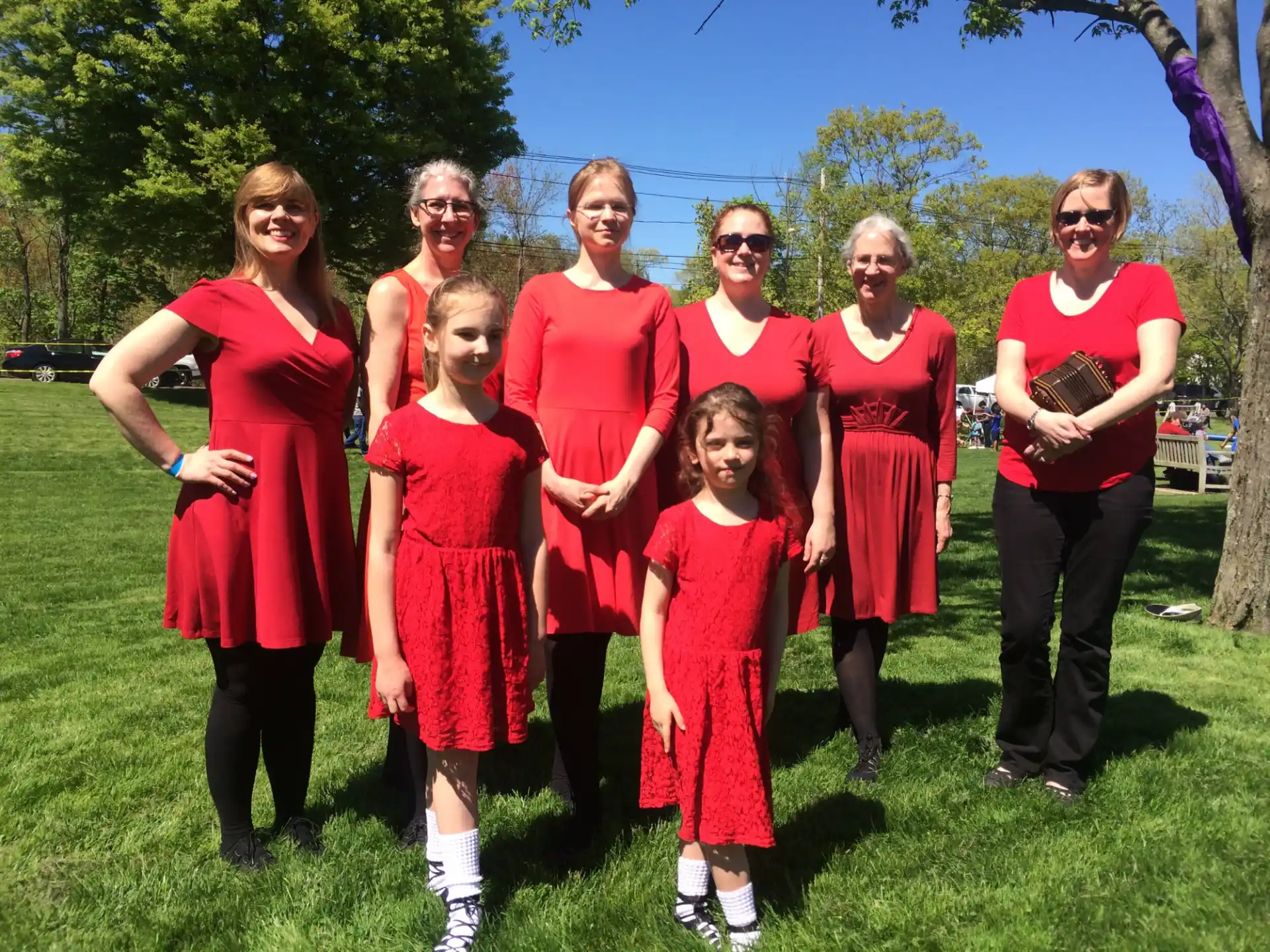a group of people in red dresses