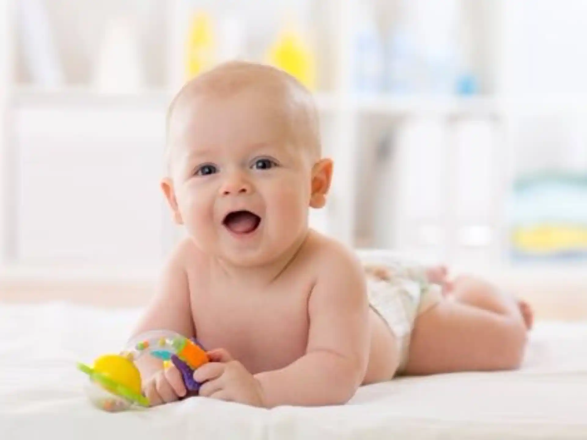 a baby lying on a bed