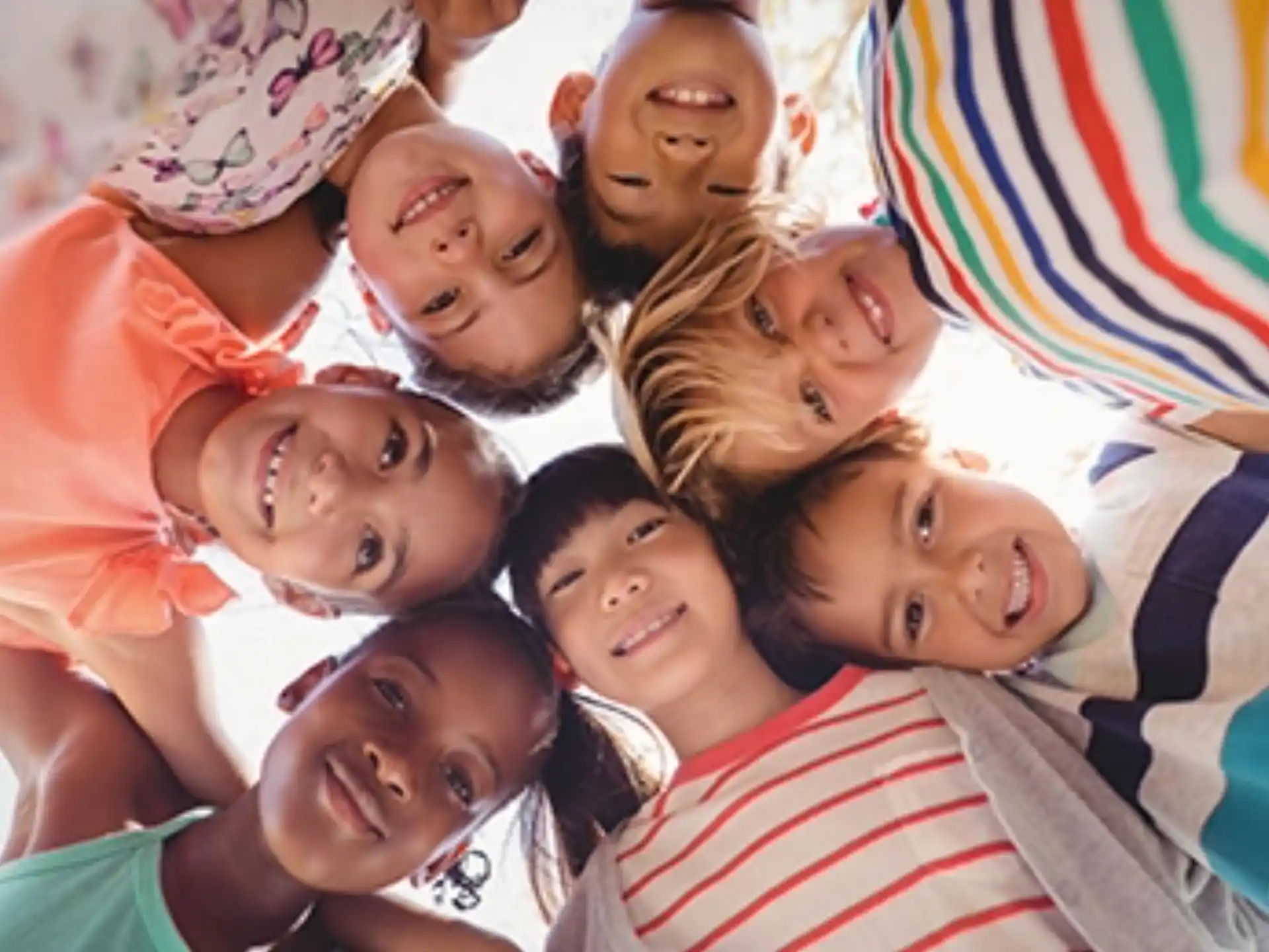 a group of people lying on the ground smiling for the camera