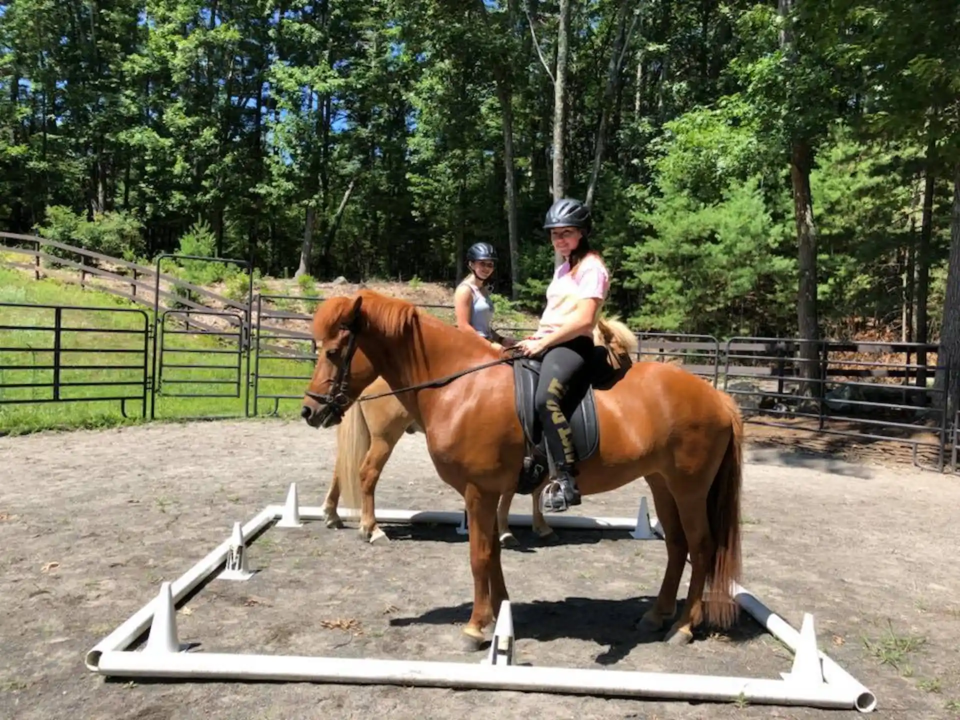 a couple of women riding horses