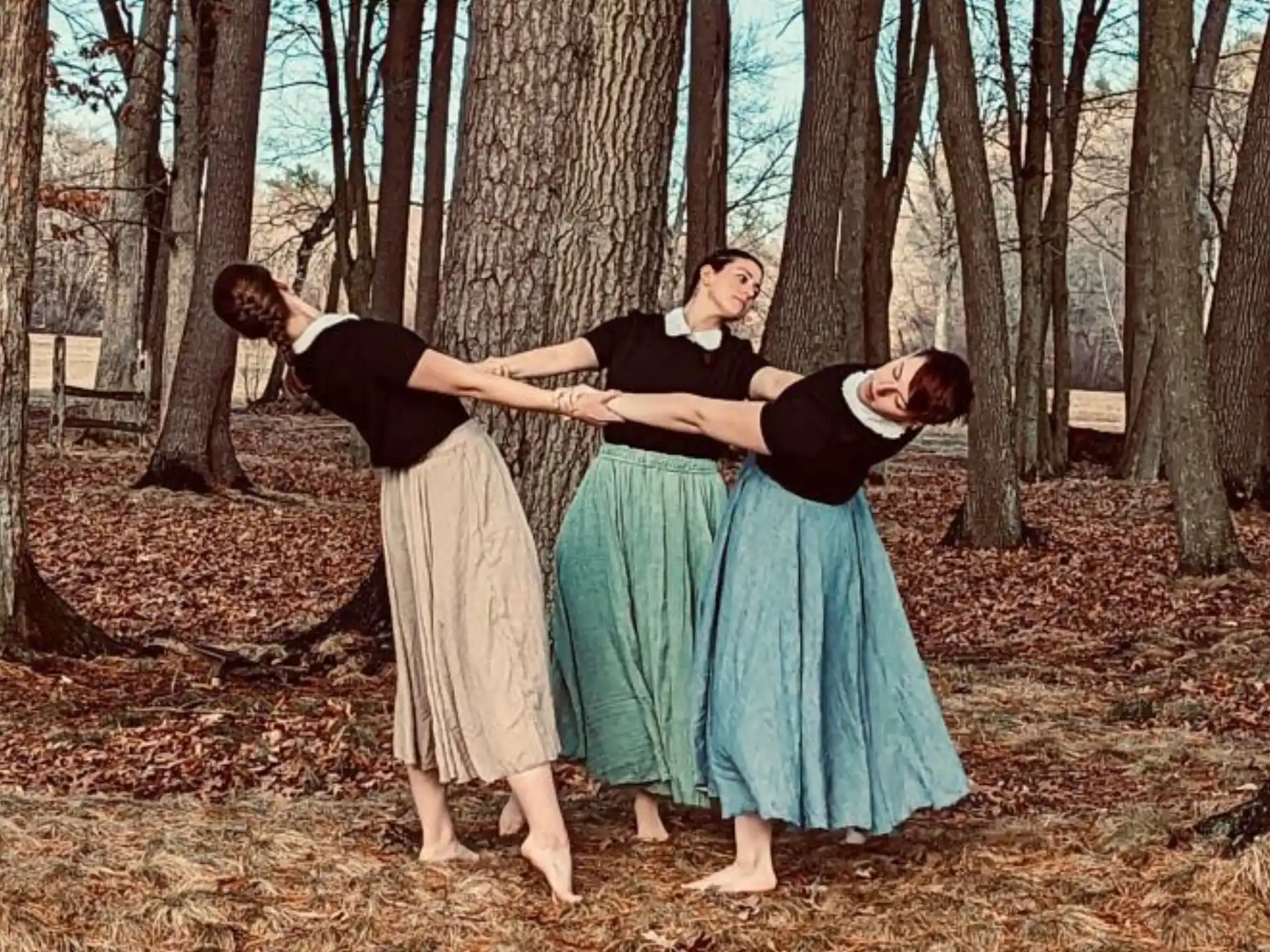a group of people dancing in a forest