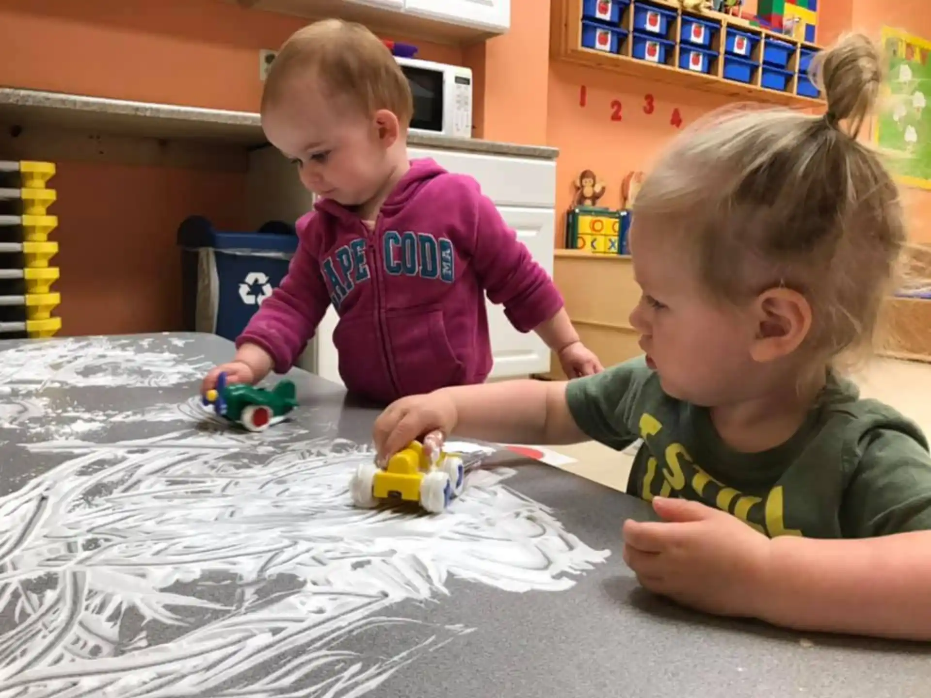 a couple of children playing with toys