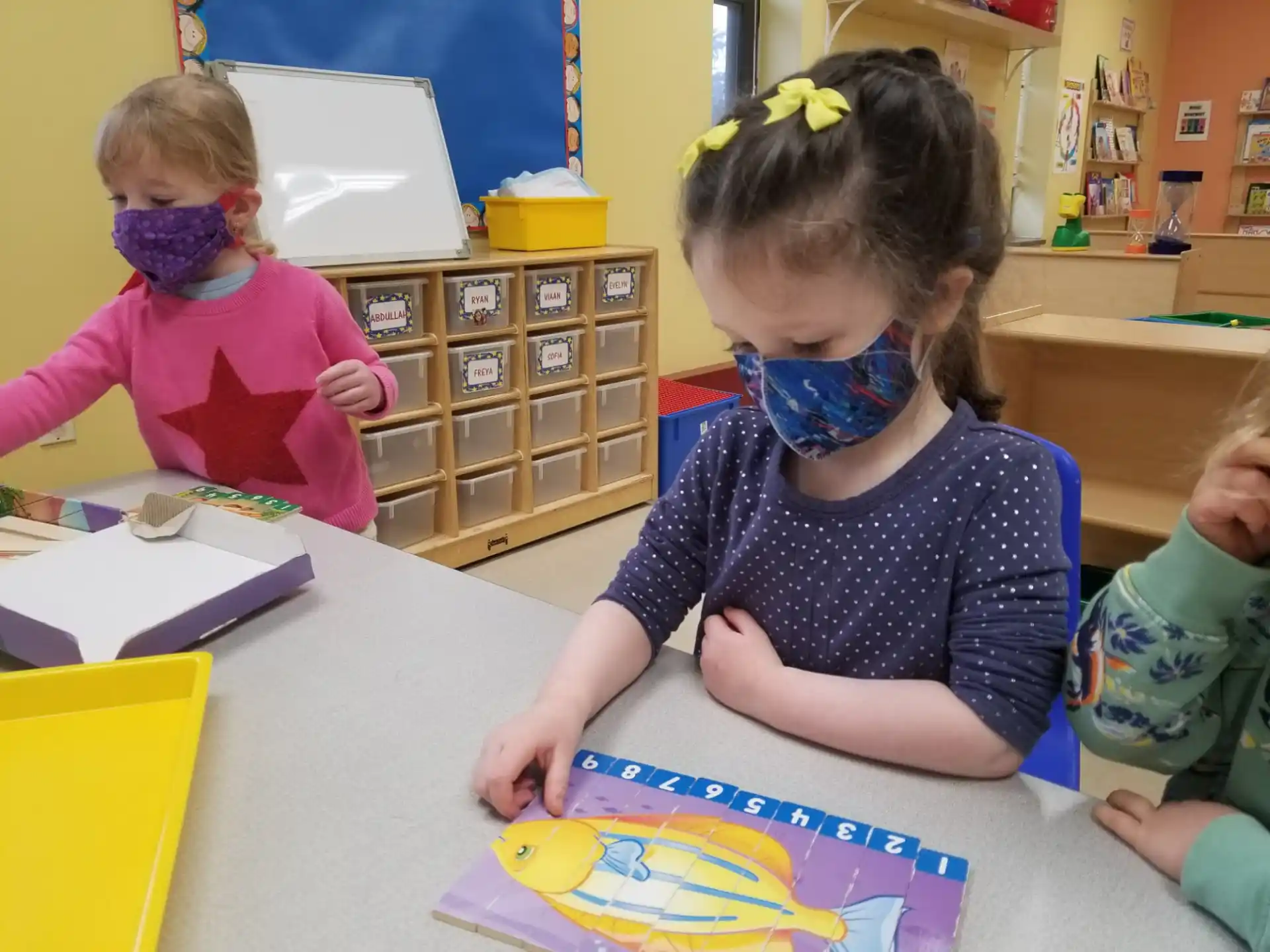 a group of children playing with a puzzle