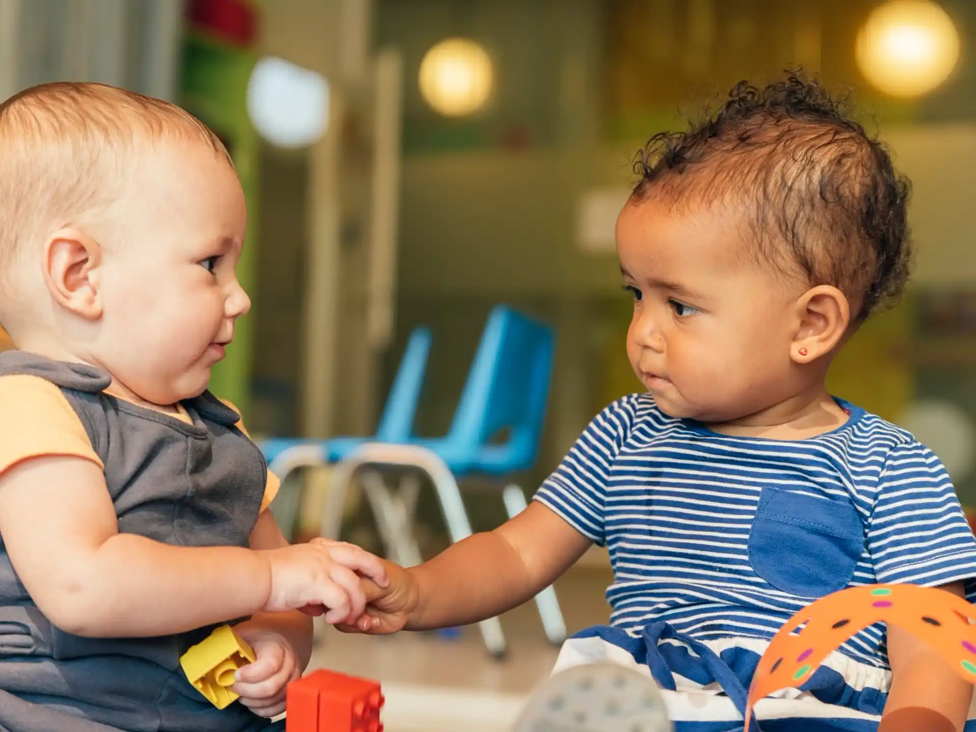a couple of young boys playing with toys