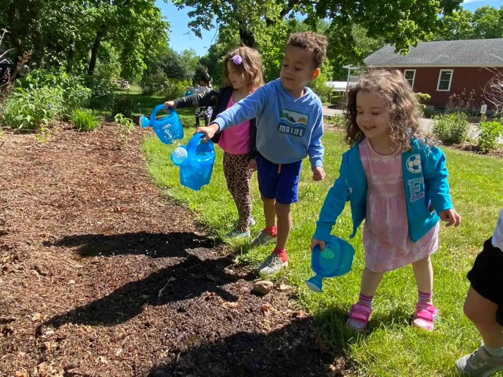 a group of children holding blue plastic toys