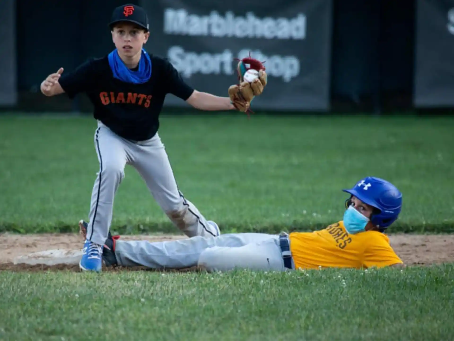 a baseball player sliding into a base