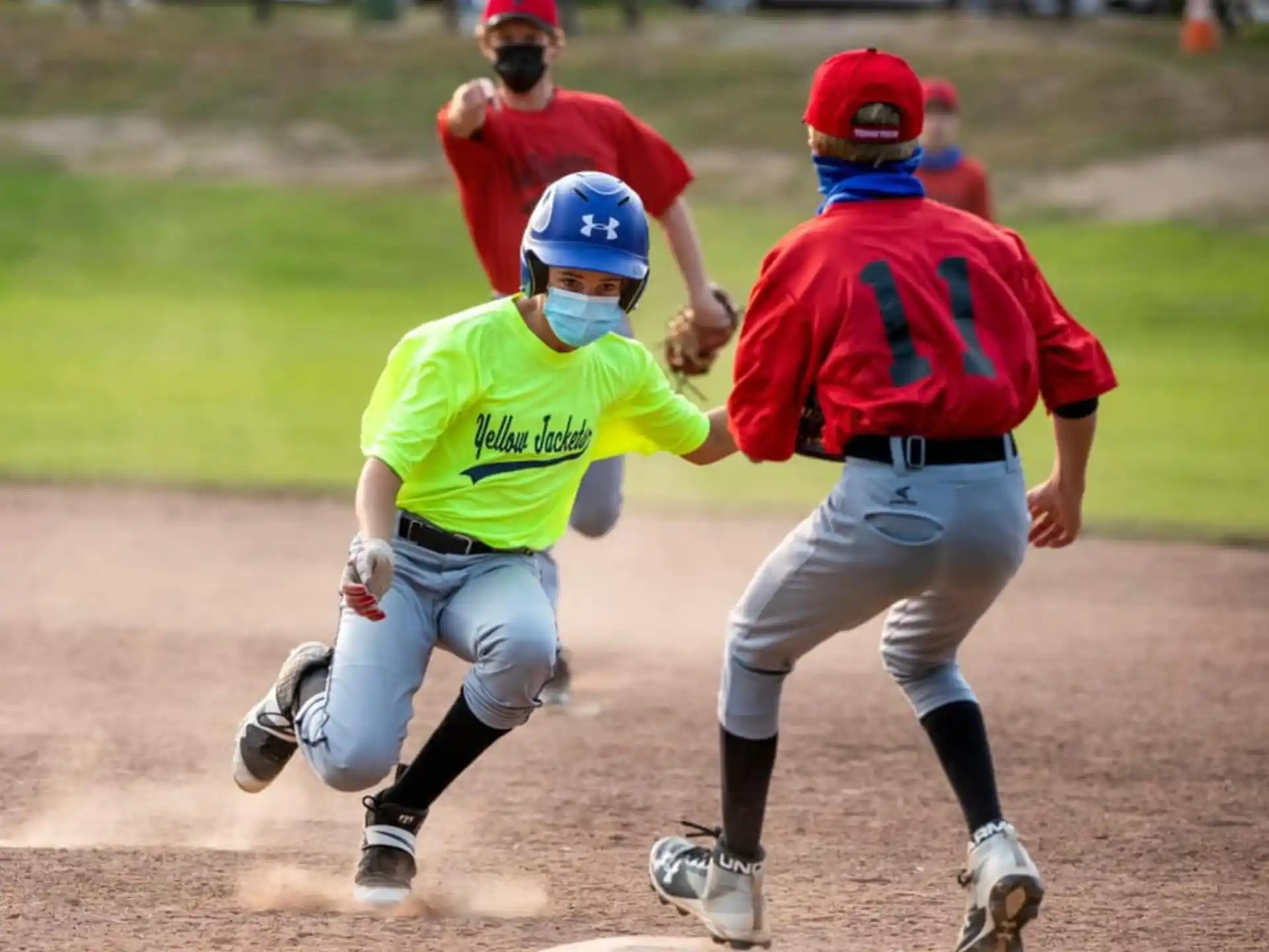 a group of people playing baseball