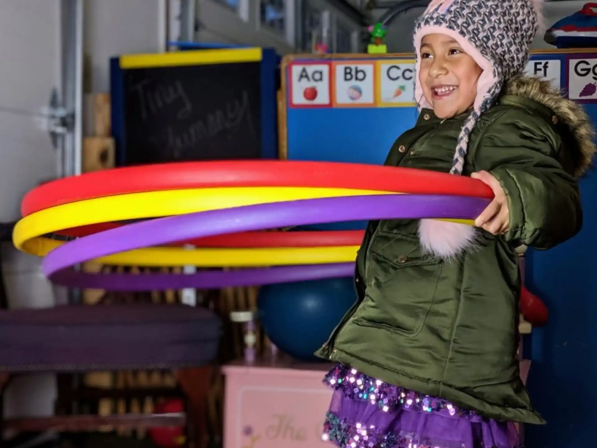 a person holding a rainbow colored object