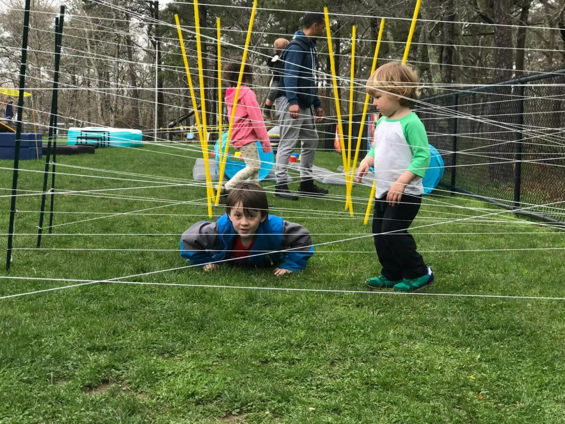 a boy and a girl playing in a playground