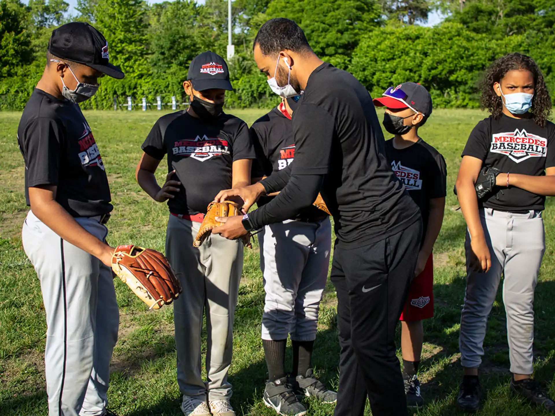 a group of kids wearing baseball gear