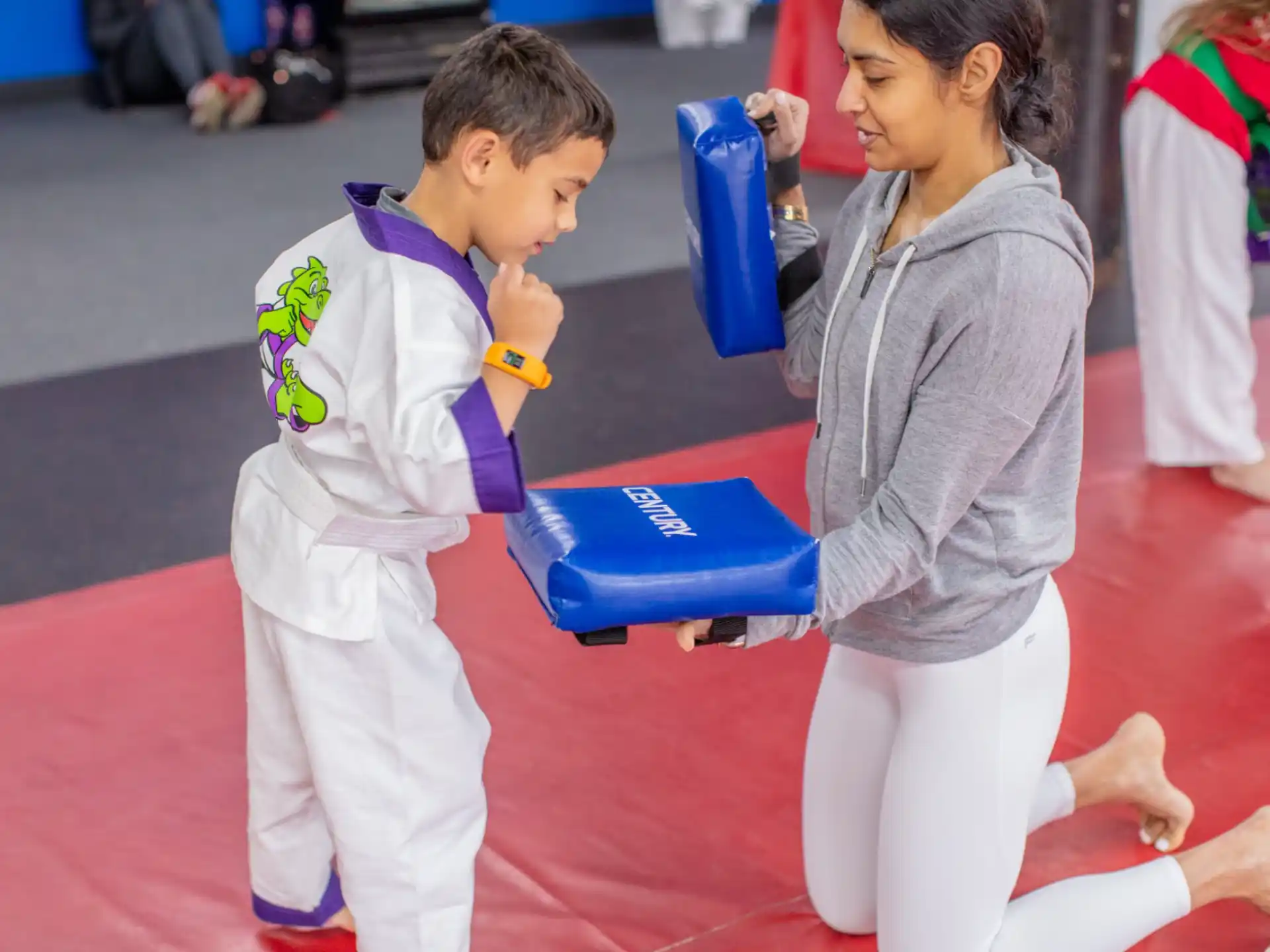 a person and a boy in karate uniforms
