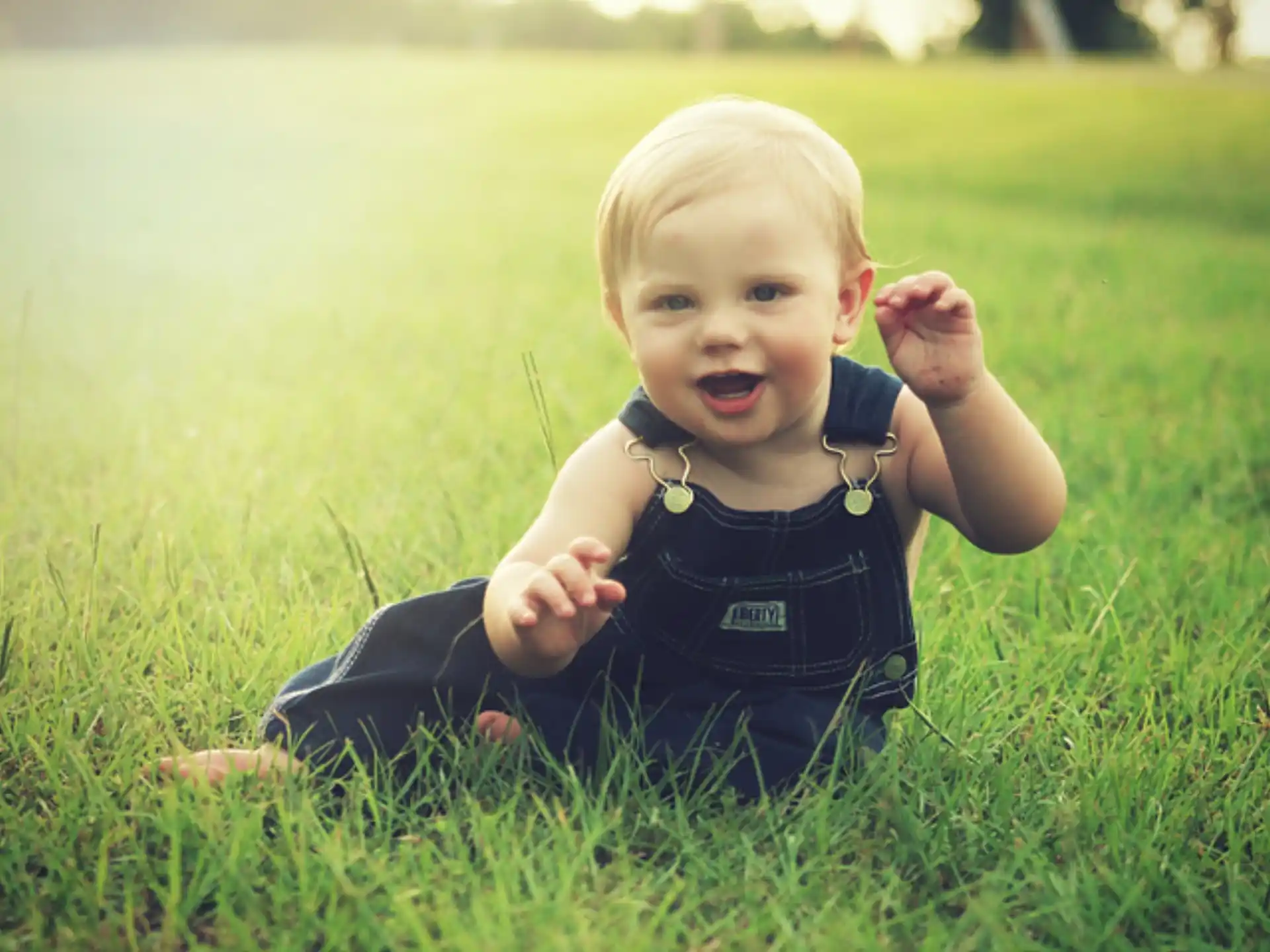 a baby lying in the grass