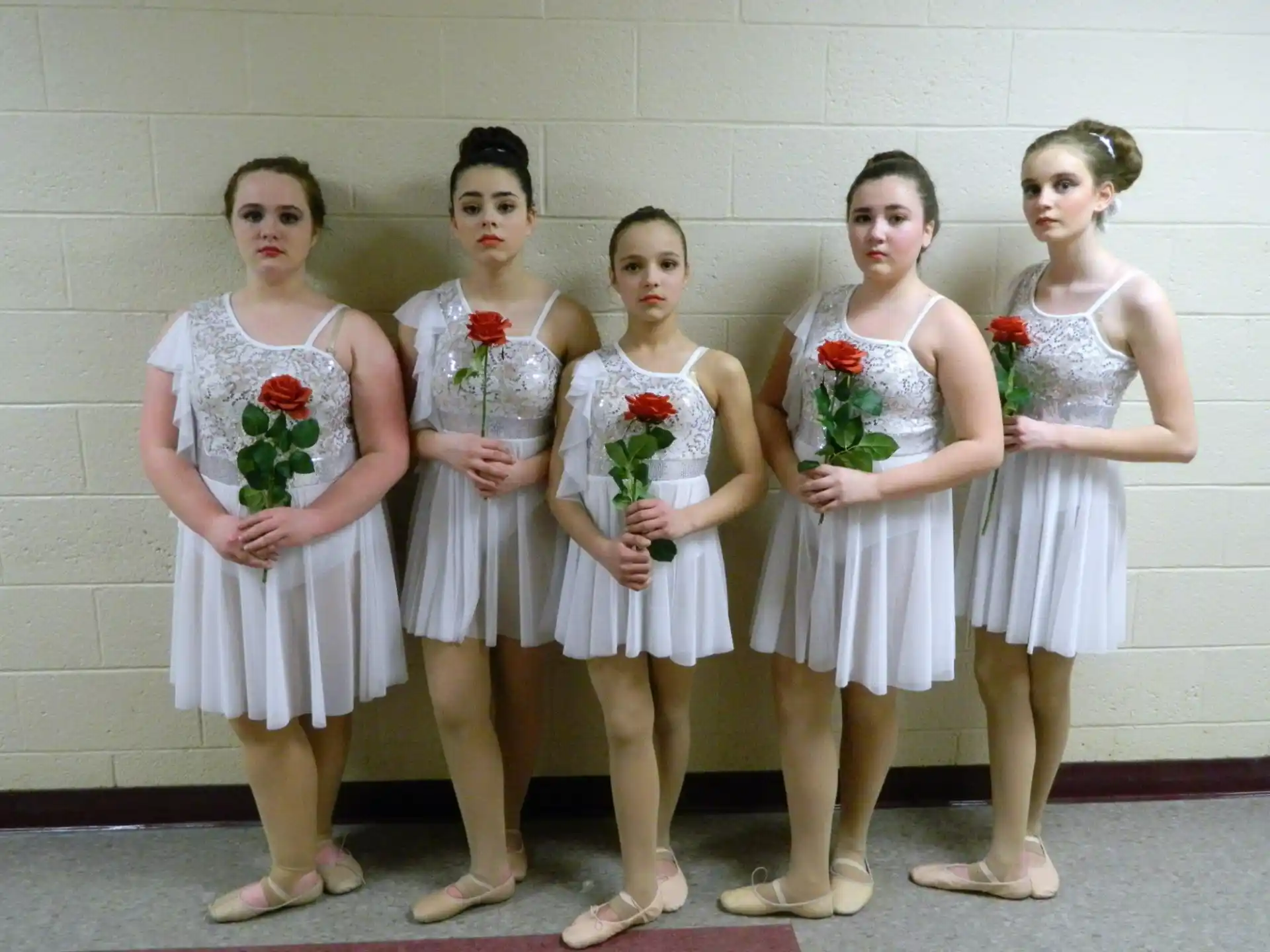 a group of girls in white dresses