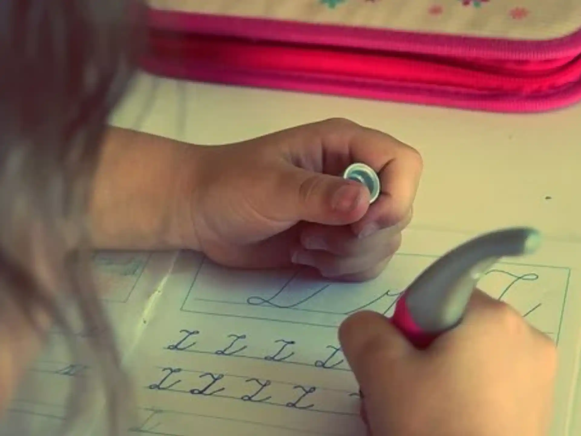a person drawing on a piece of paper
