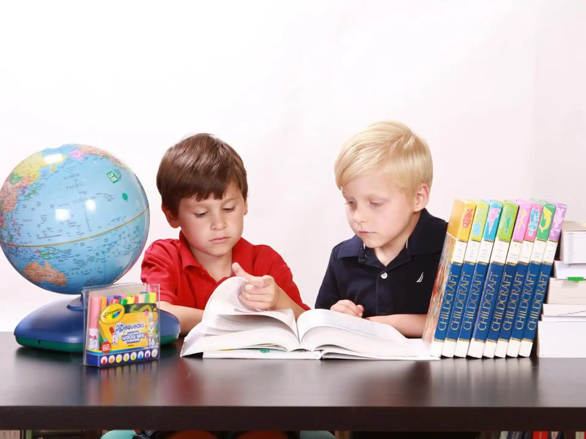 two boys sitting at a table