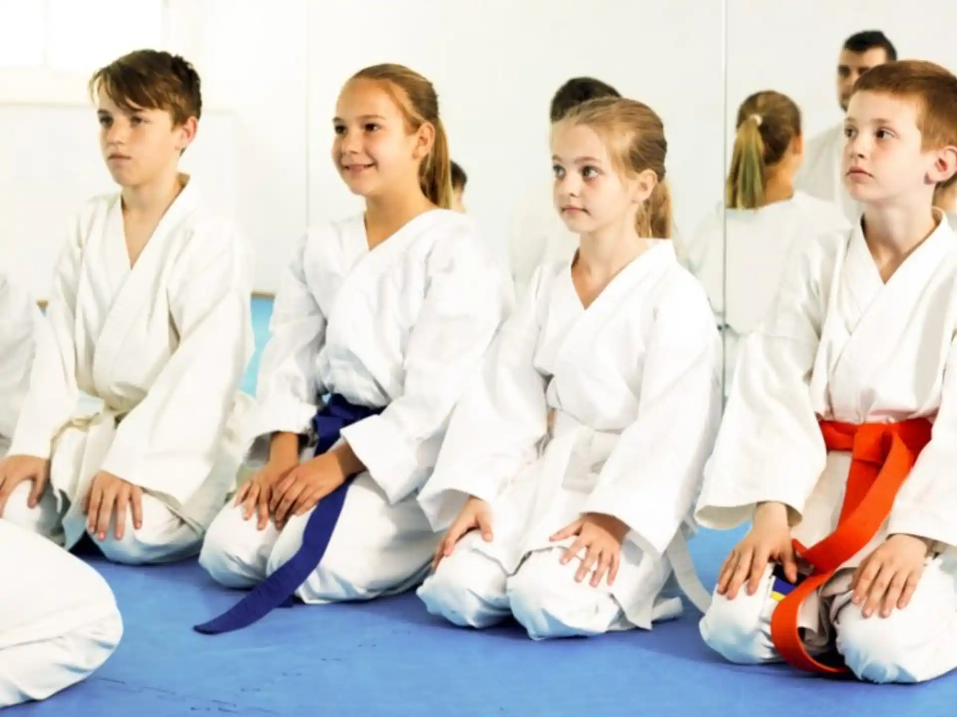 a group of people in white karate uniforms