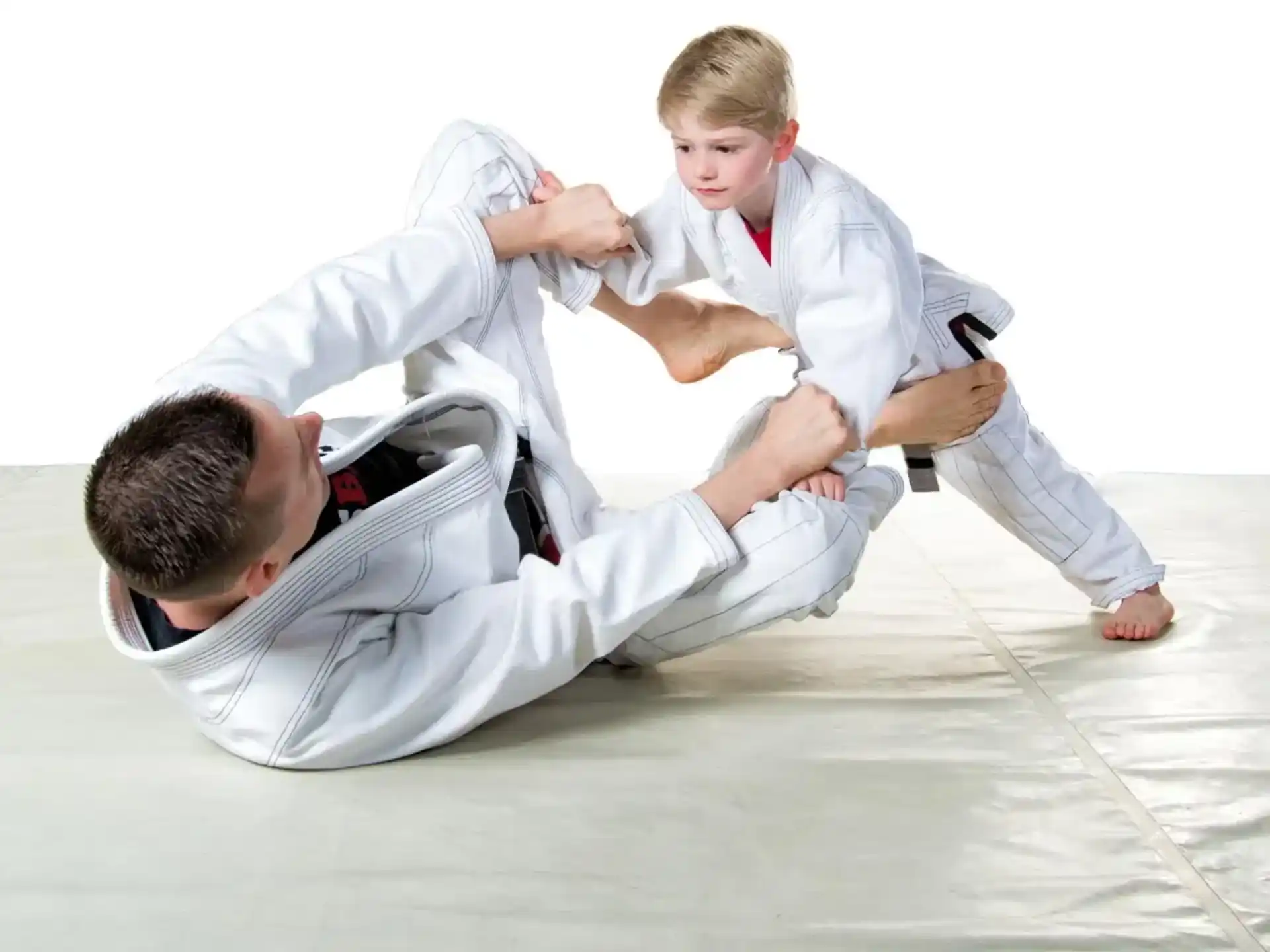 a man in white karate uniform kicking another man in the face