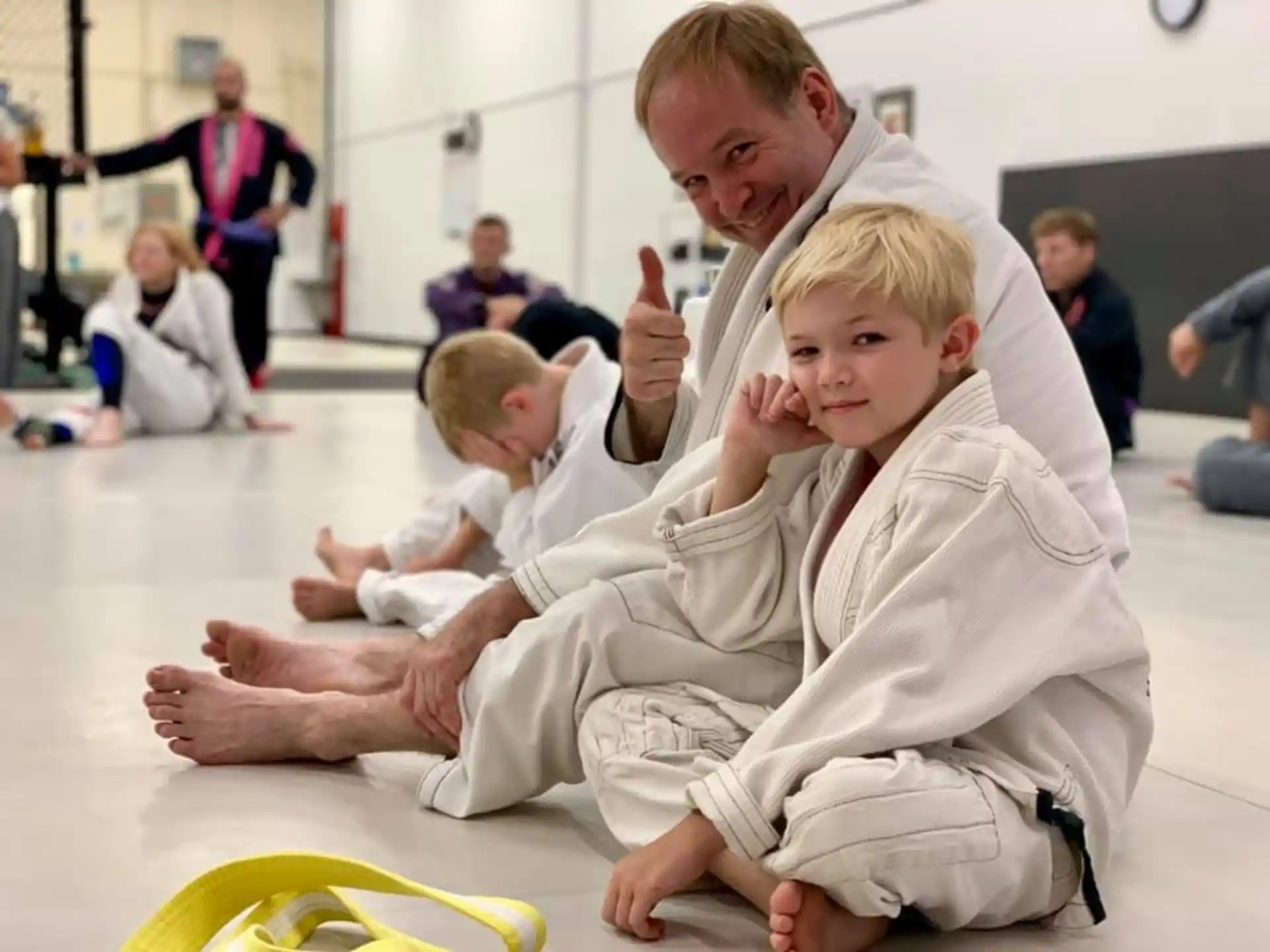 a group of children in karate uniforms