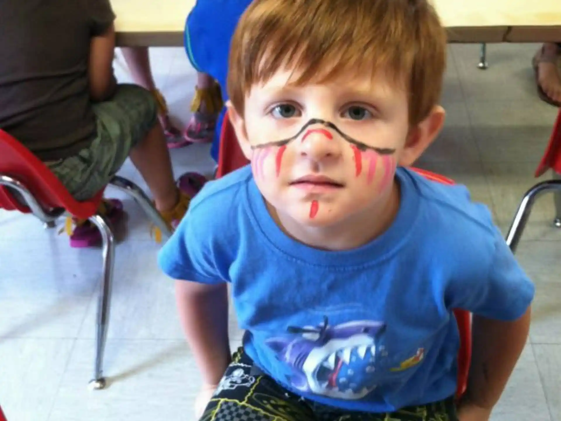 a boy with a face drawn on his face