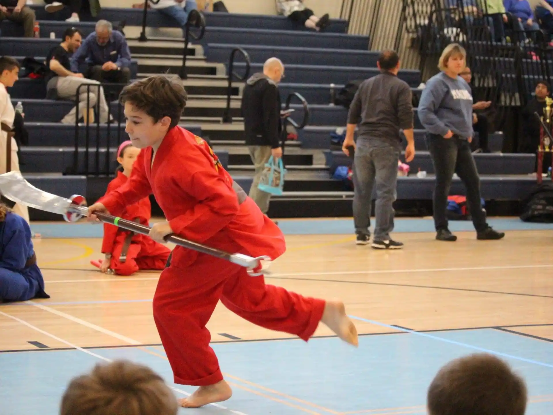 a boy in a red karate uniform