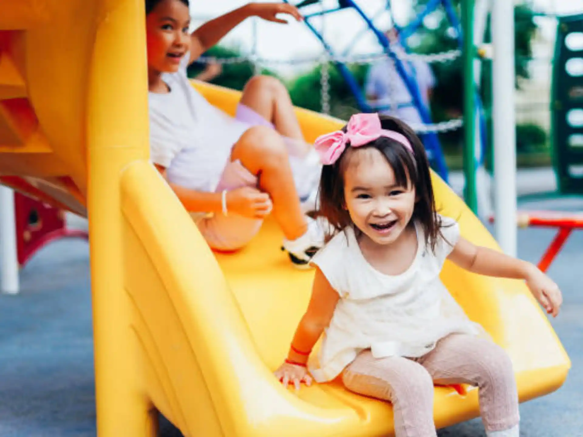 a couple of kids playing on a playground
