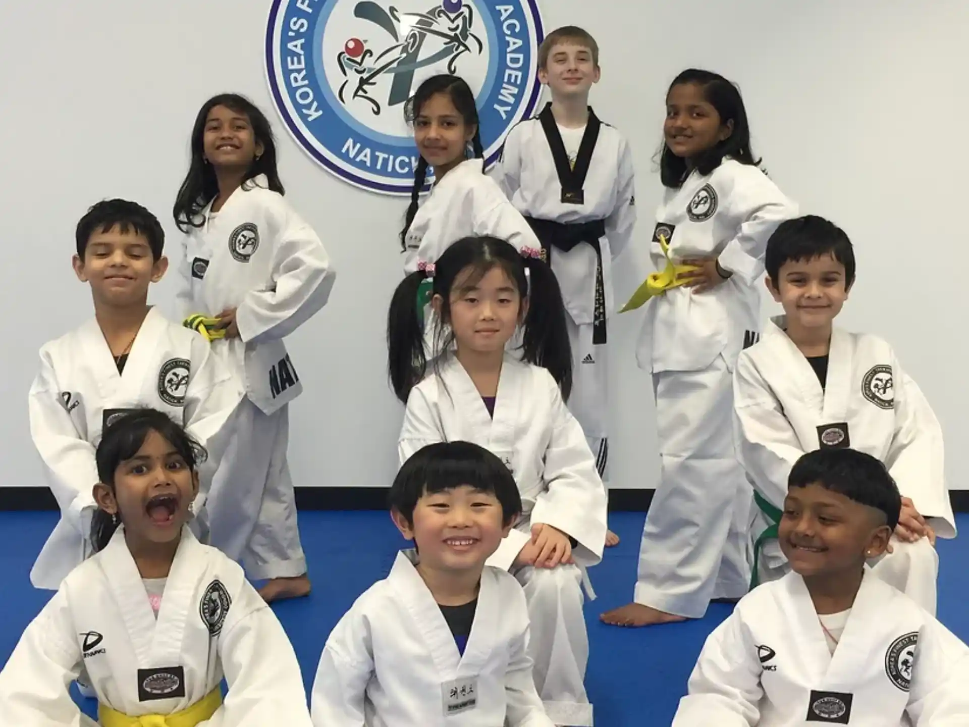 a group of people in white karate uniforms