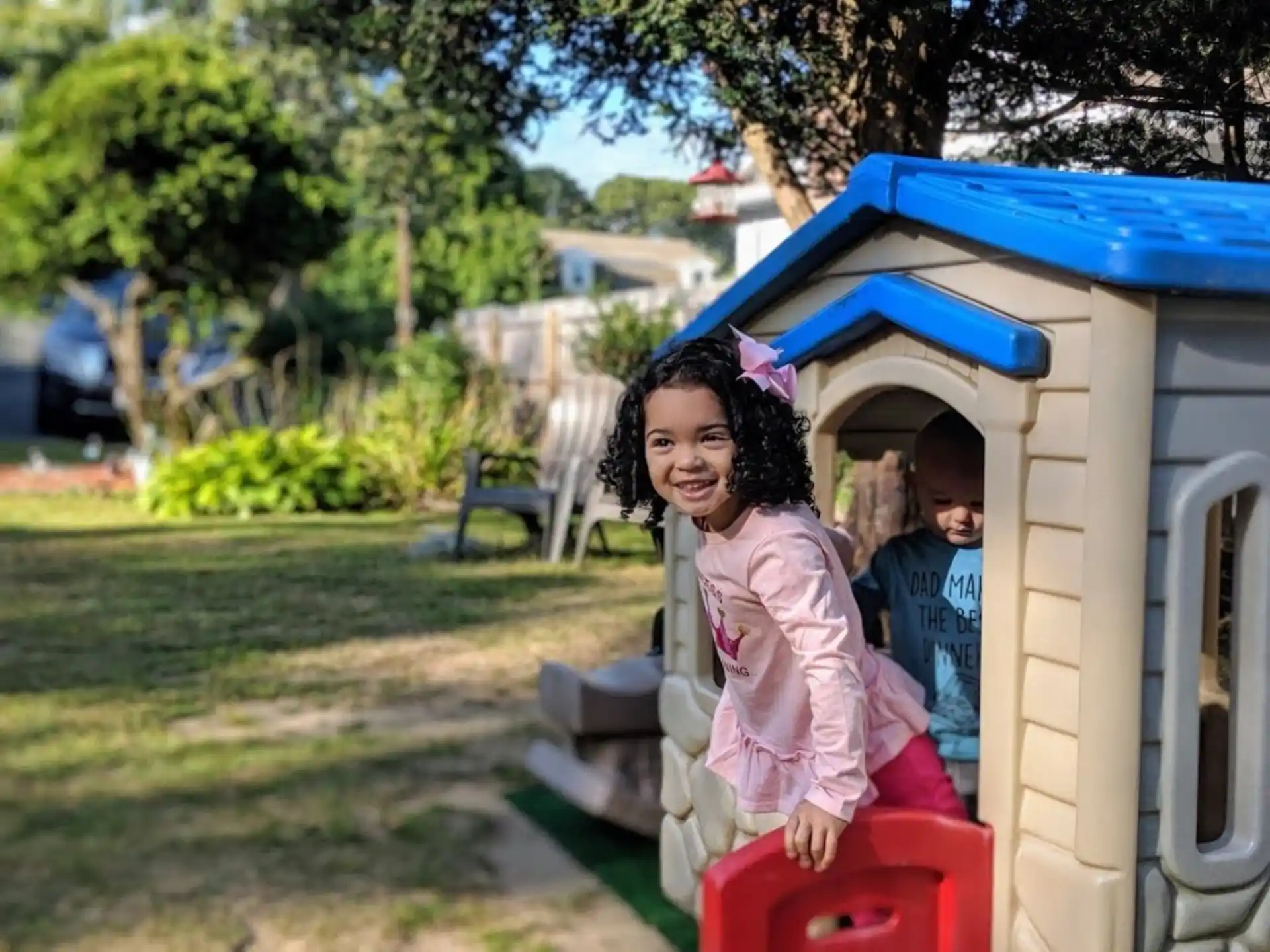 a girl in a pink dress in a play structure