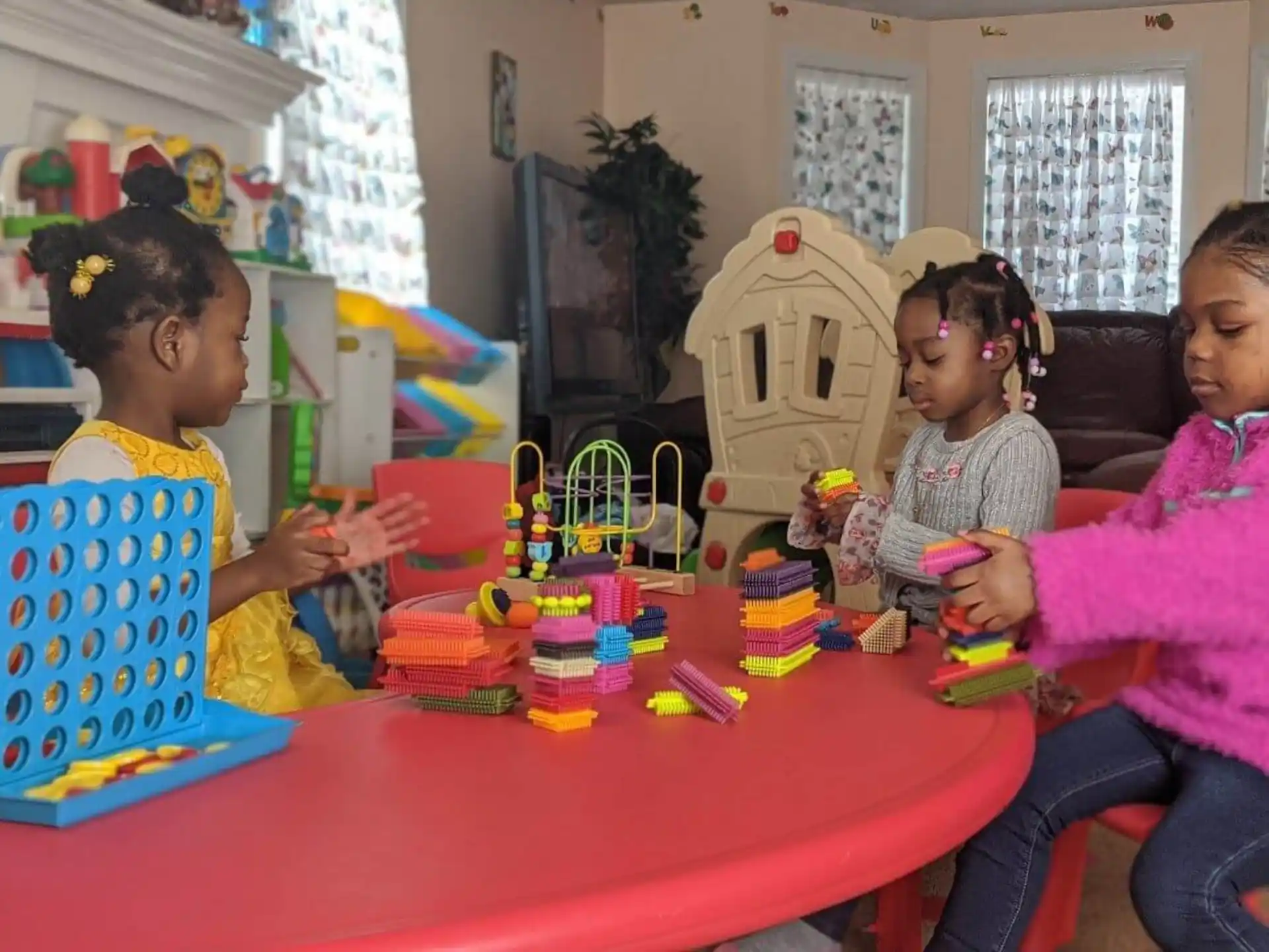 a group of people sitting around a table with a robot