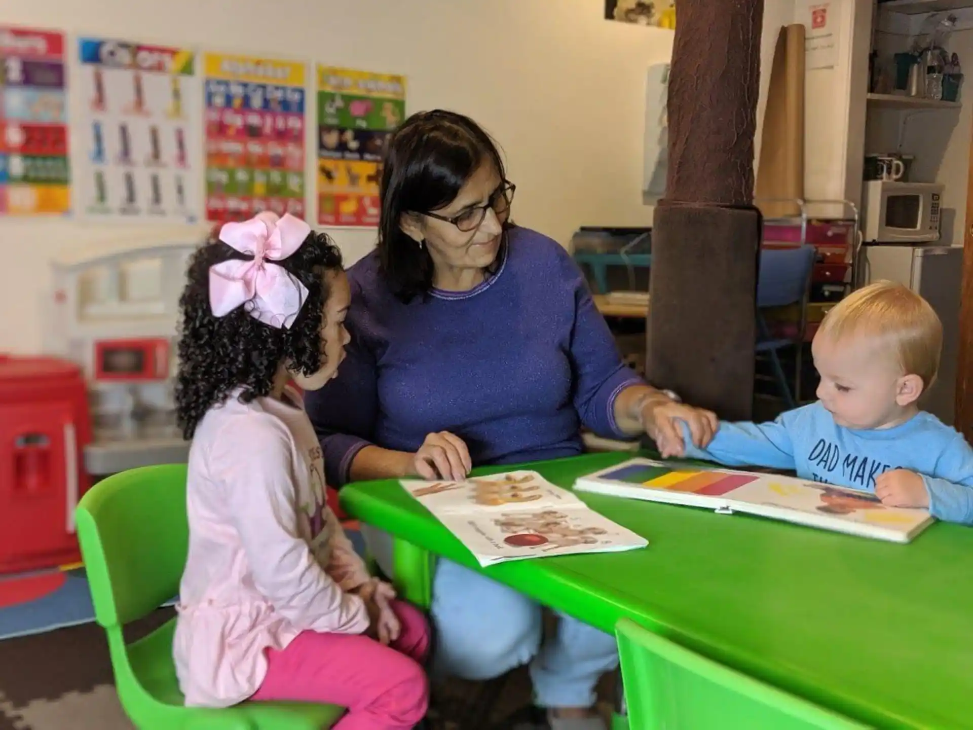 a person and two children sitting at a table