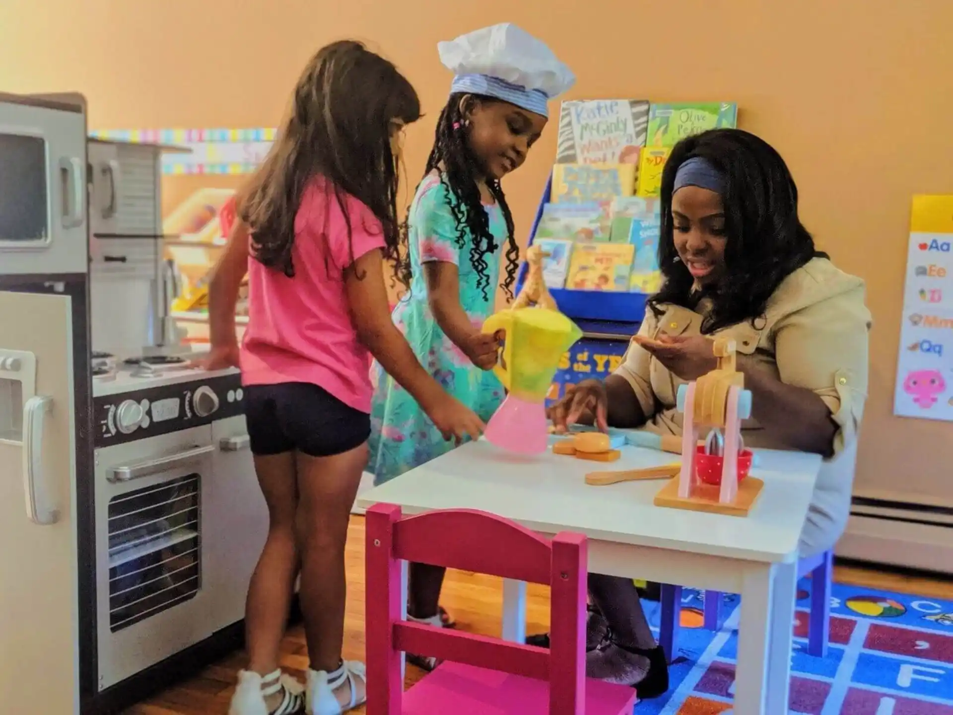 a group of women standing around a table with food on it