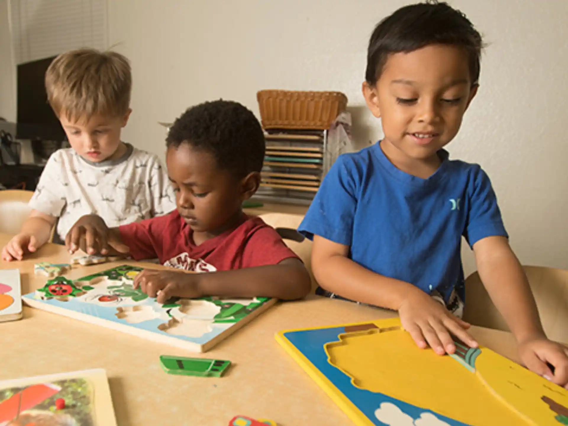a few young boys sitting at a table