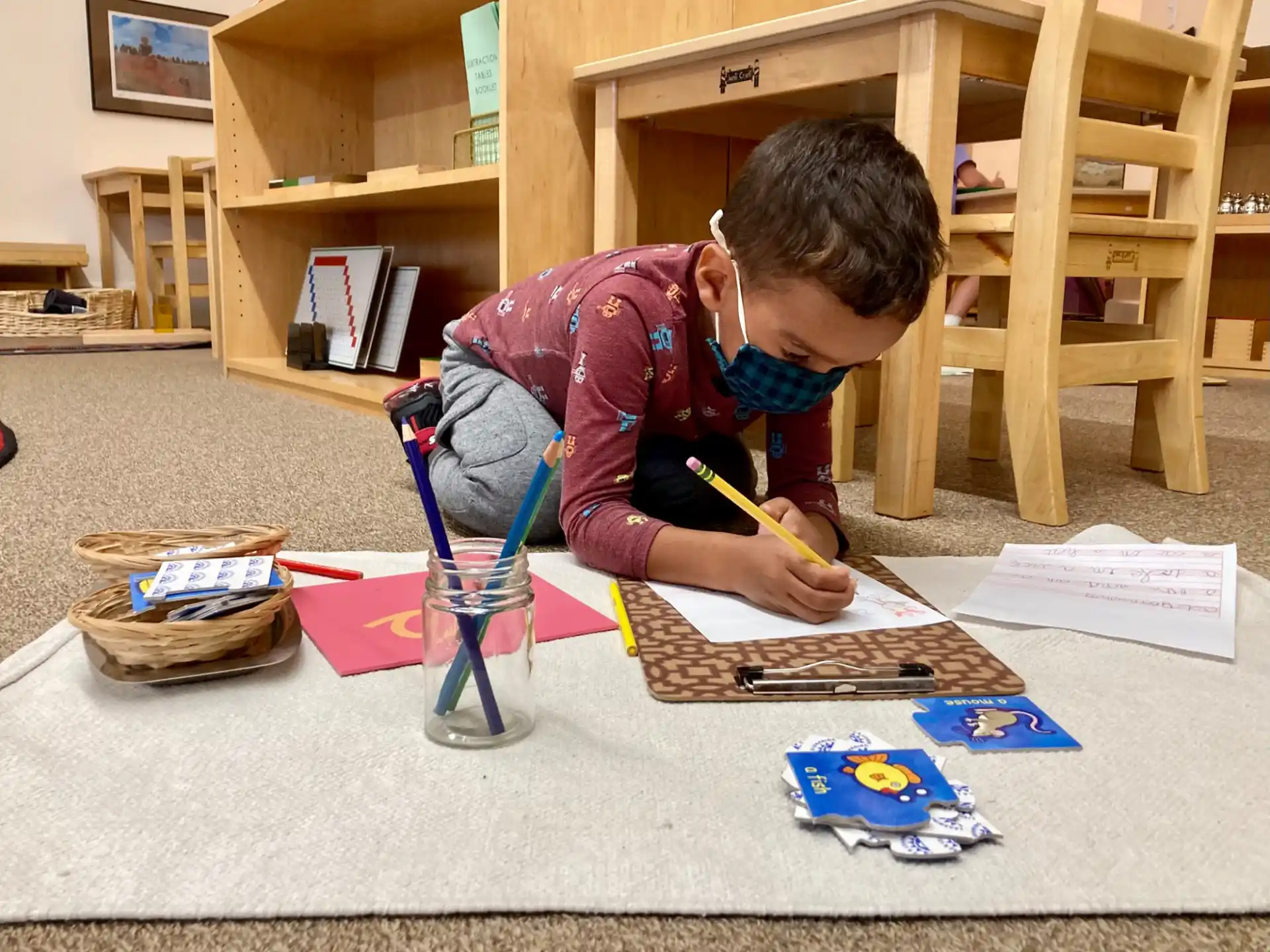 a young boy painting on a table