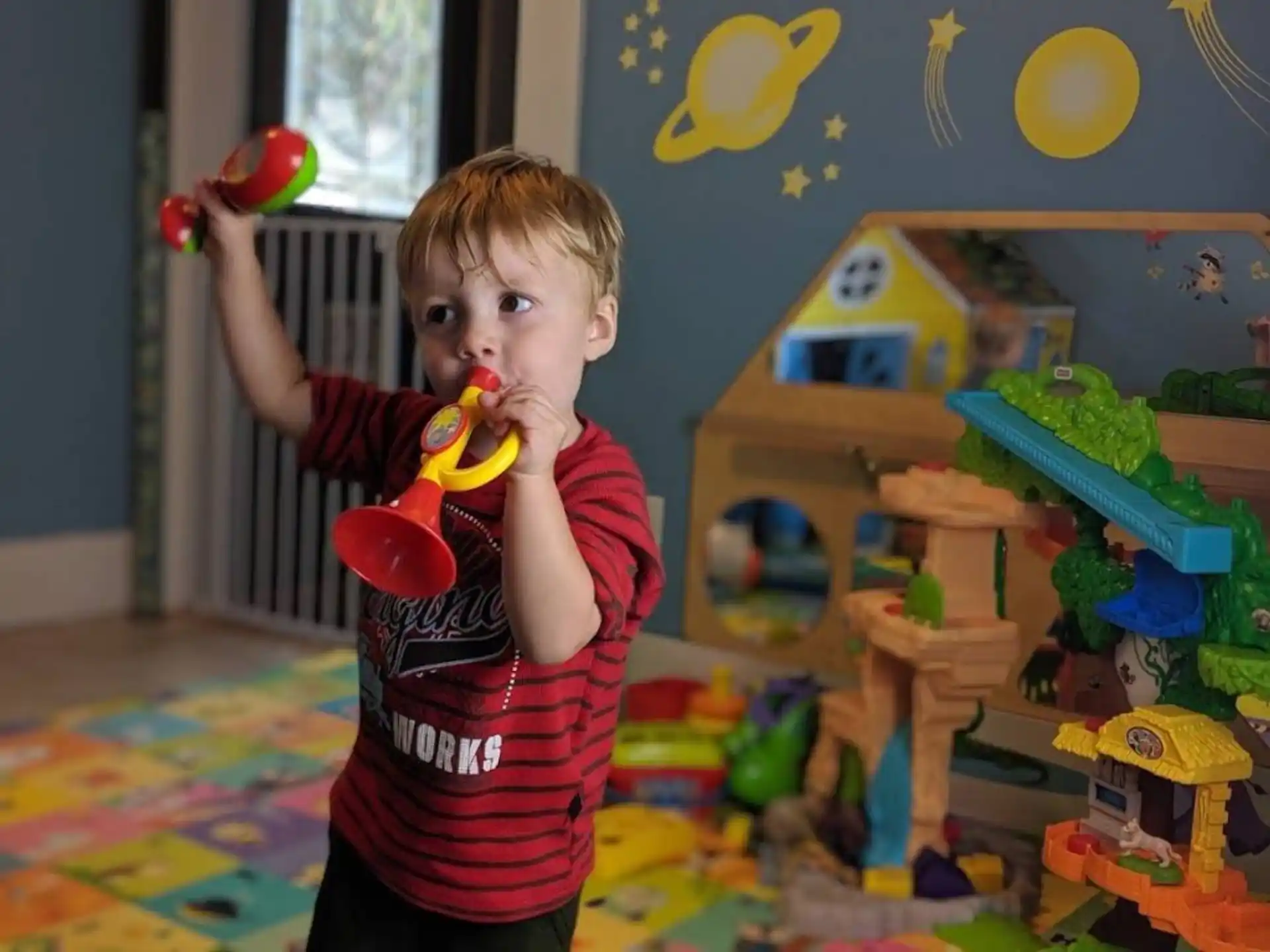 a boy holding a toy
