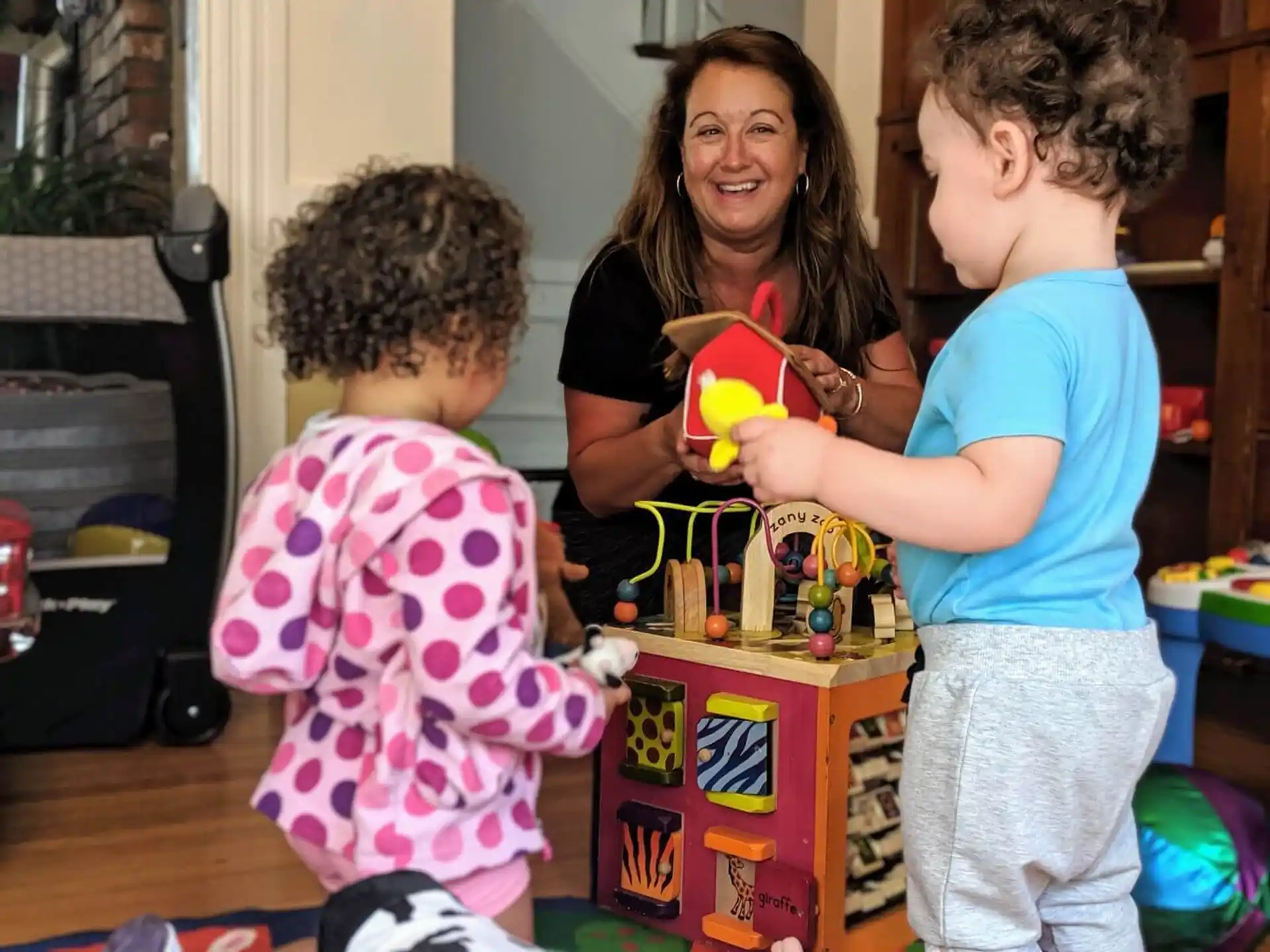a person and two children playing with toys