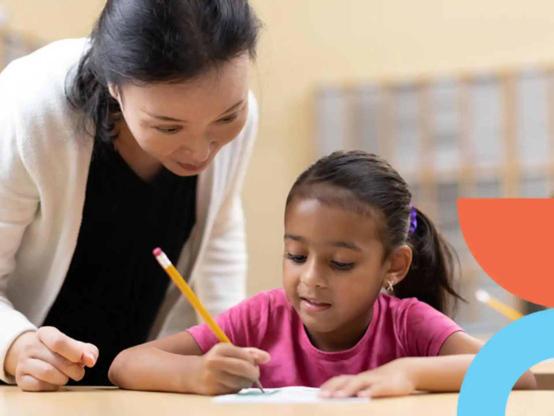 a person and a child writing on a paper