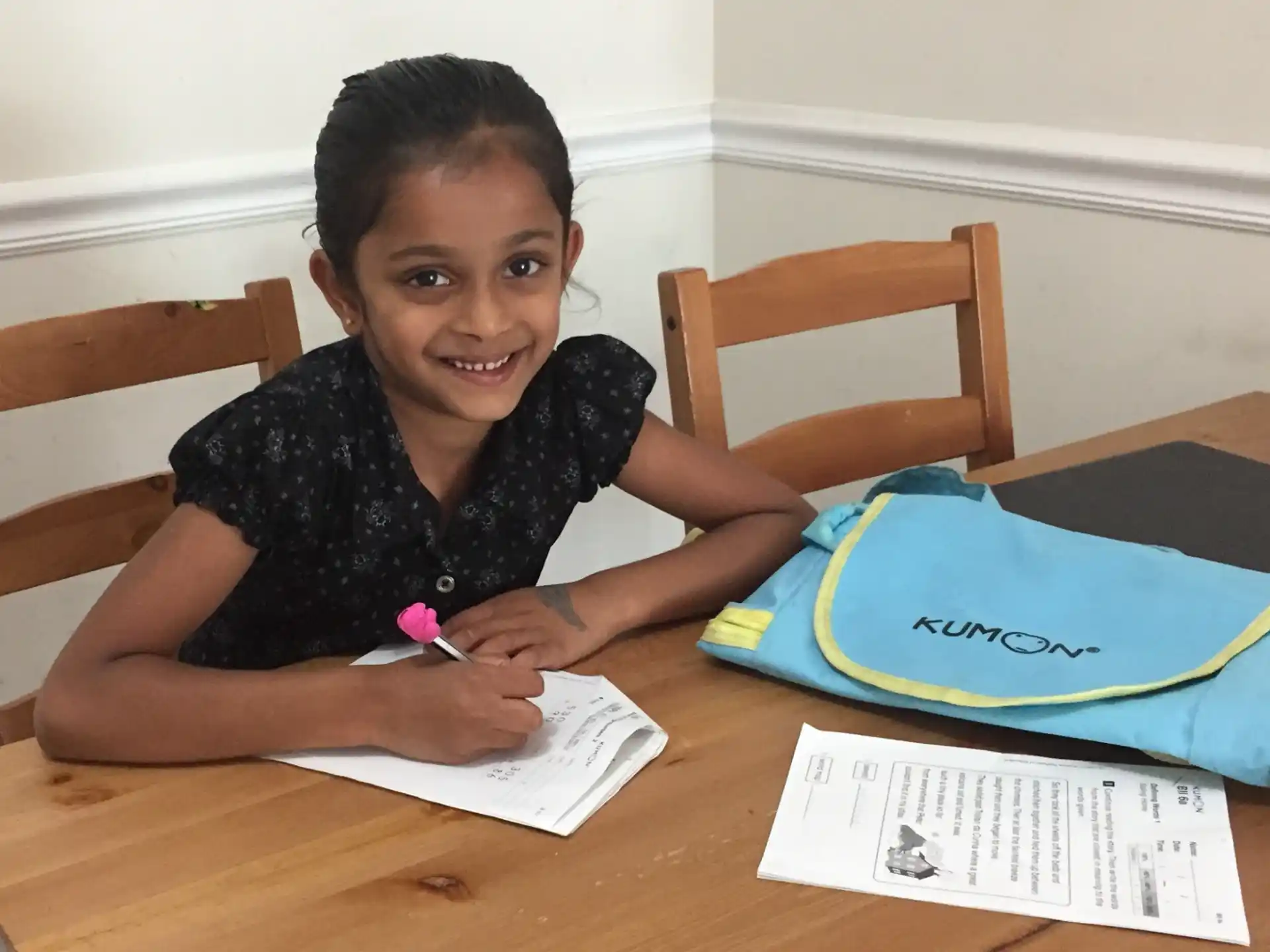 a girl sitting at a table