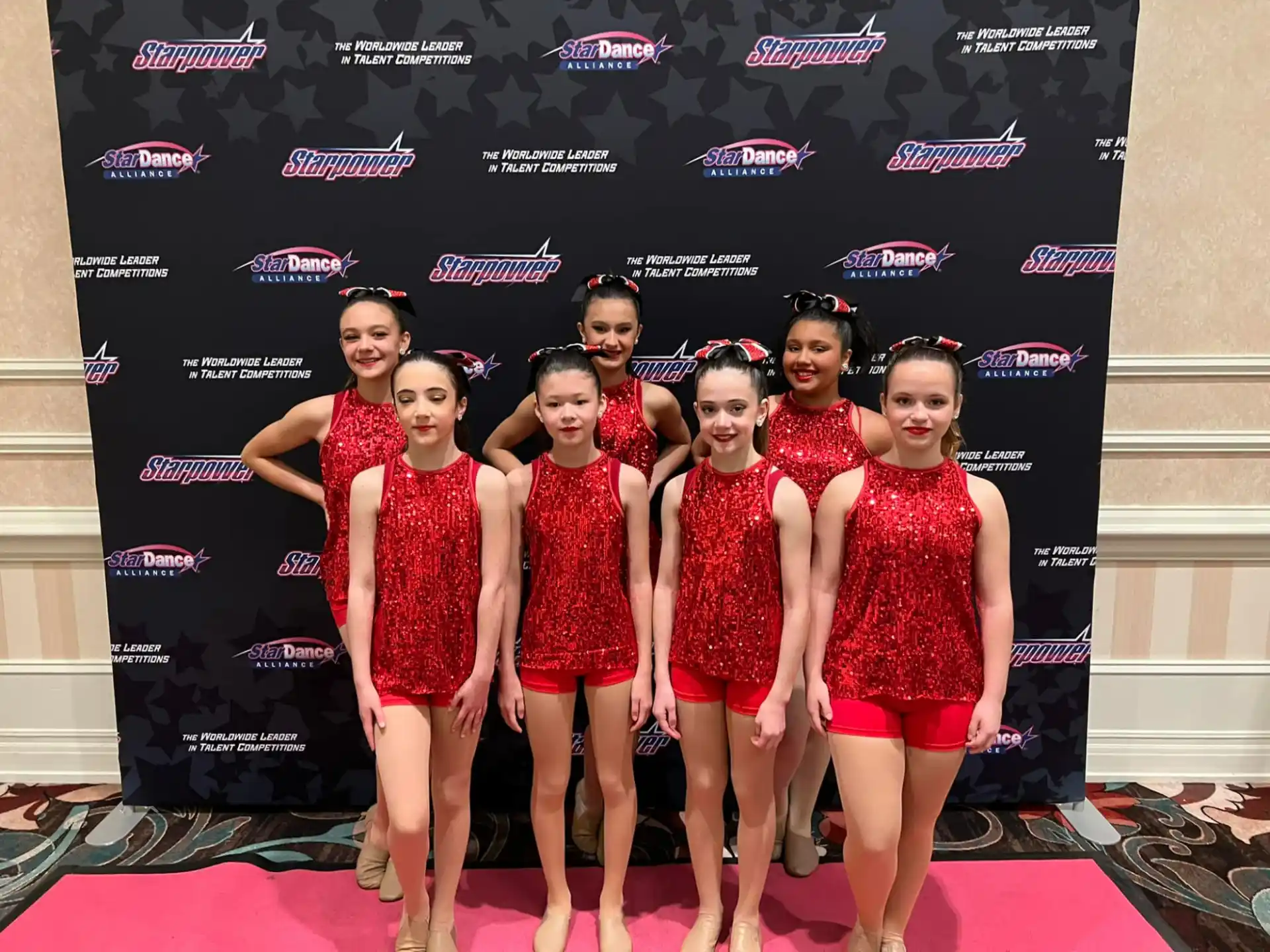 a group of women in red dresses