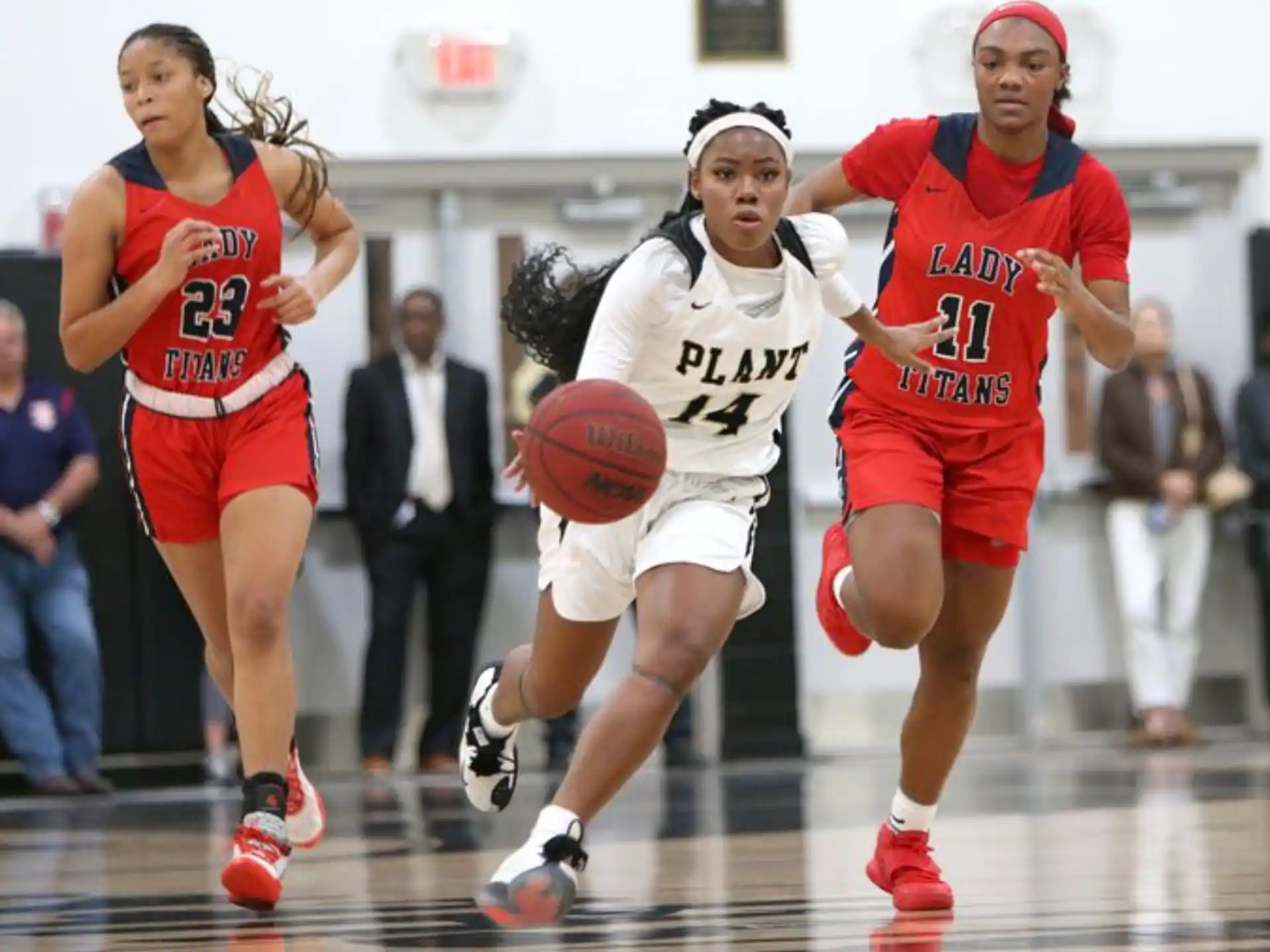a group of women playing basketball