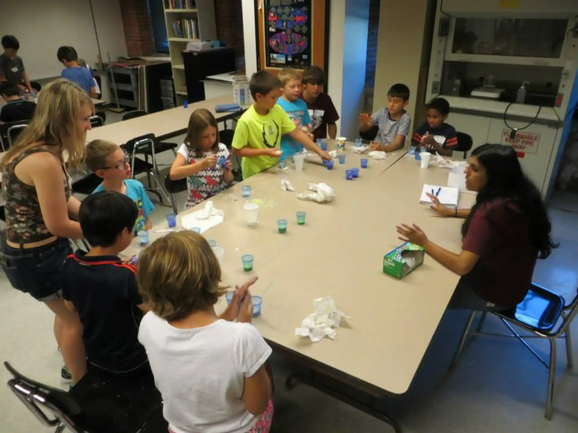 a group of children sitting around a table