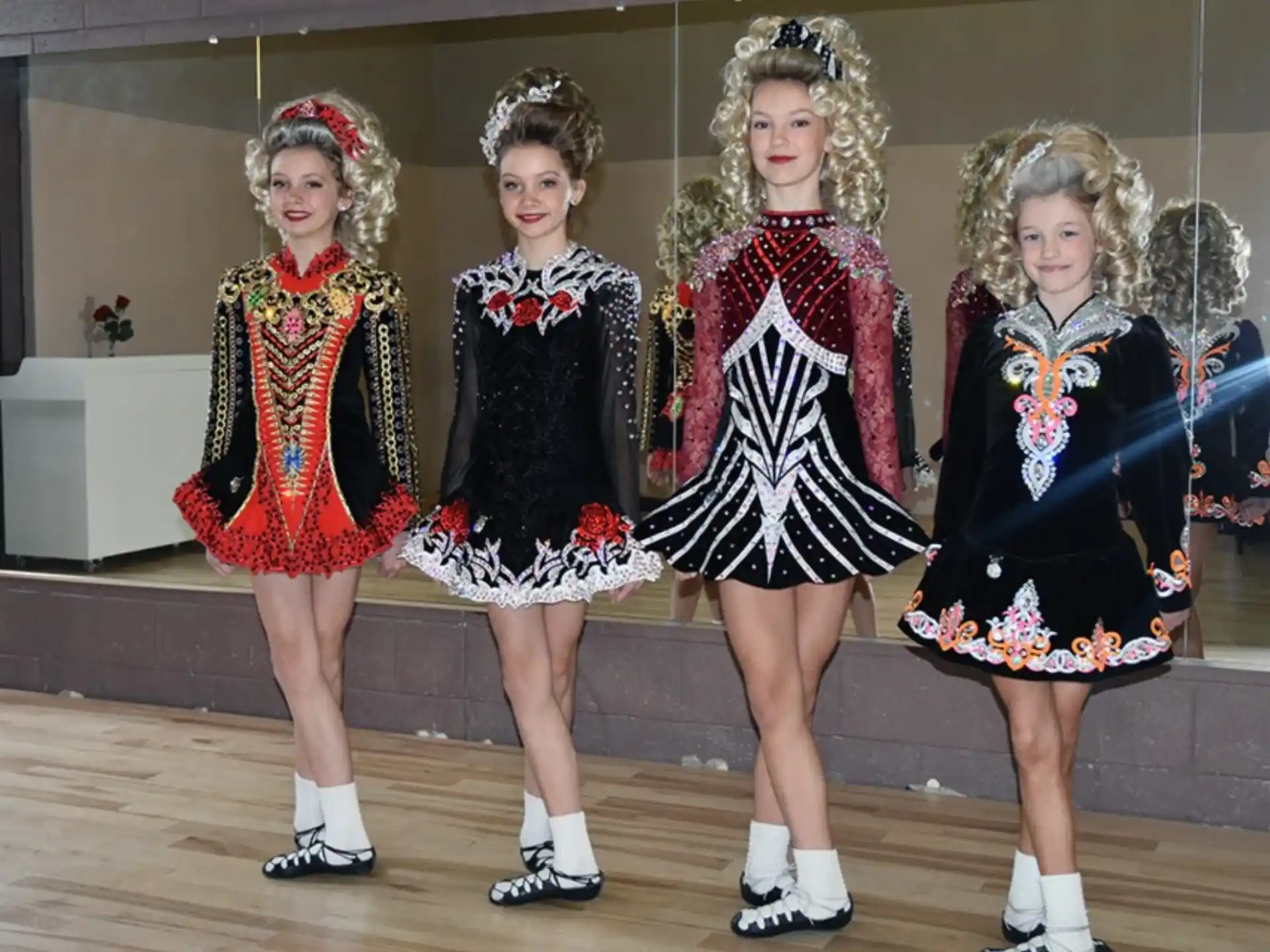 a group of girls in dresses