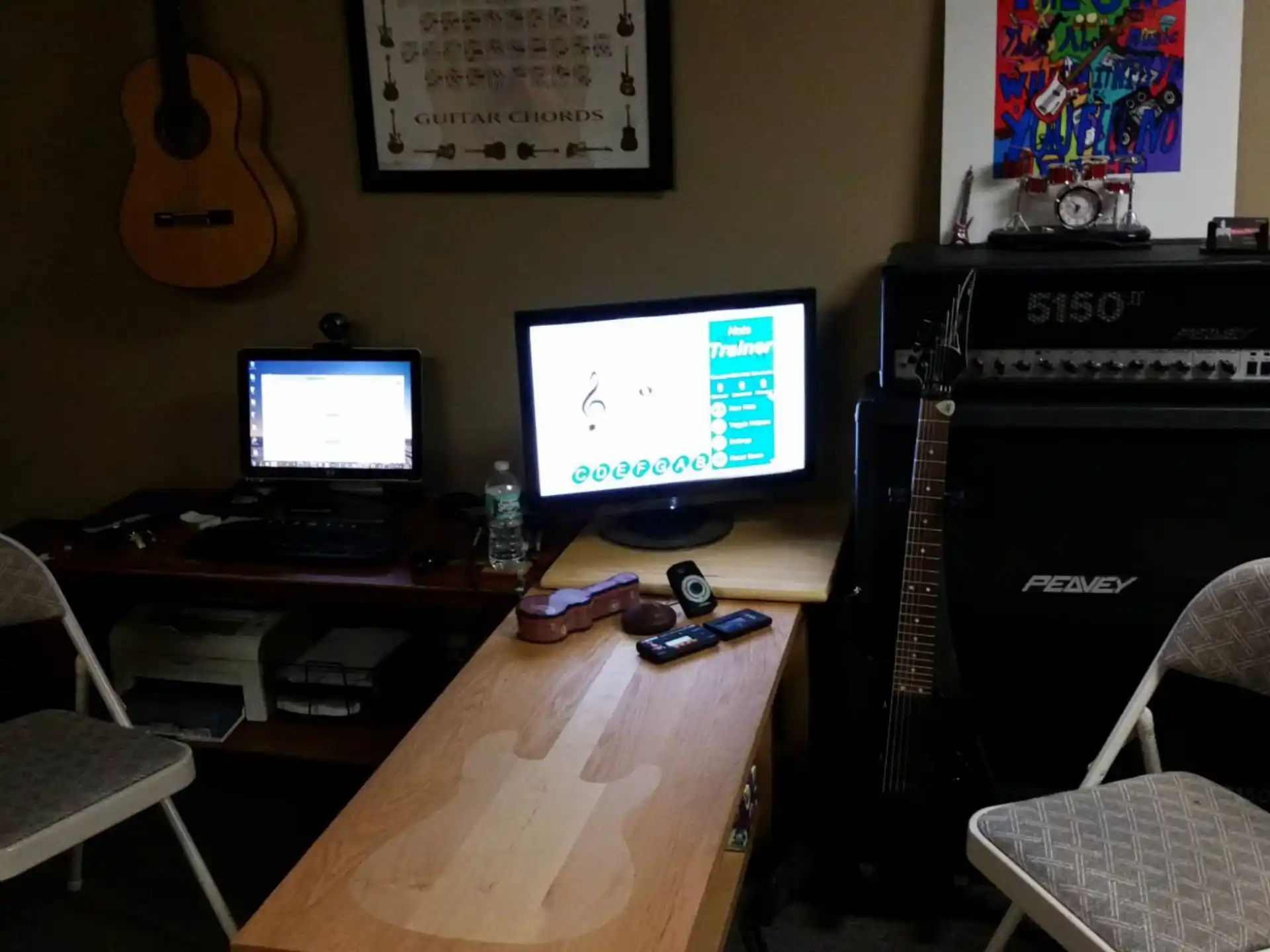 a desk with a piano and a computer on it